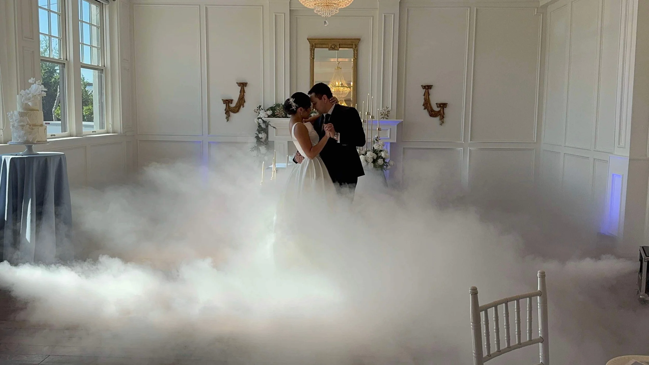 Newlywed couple "dancing on clouds" with fog generator