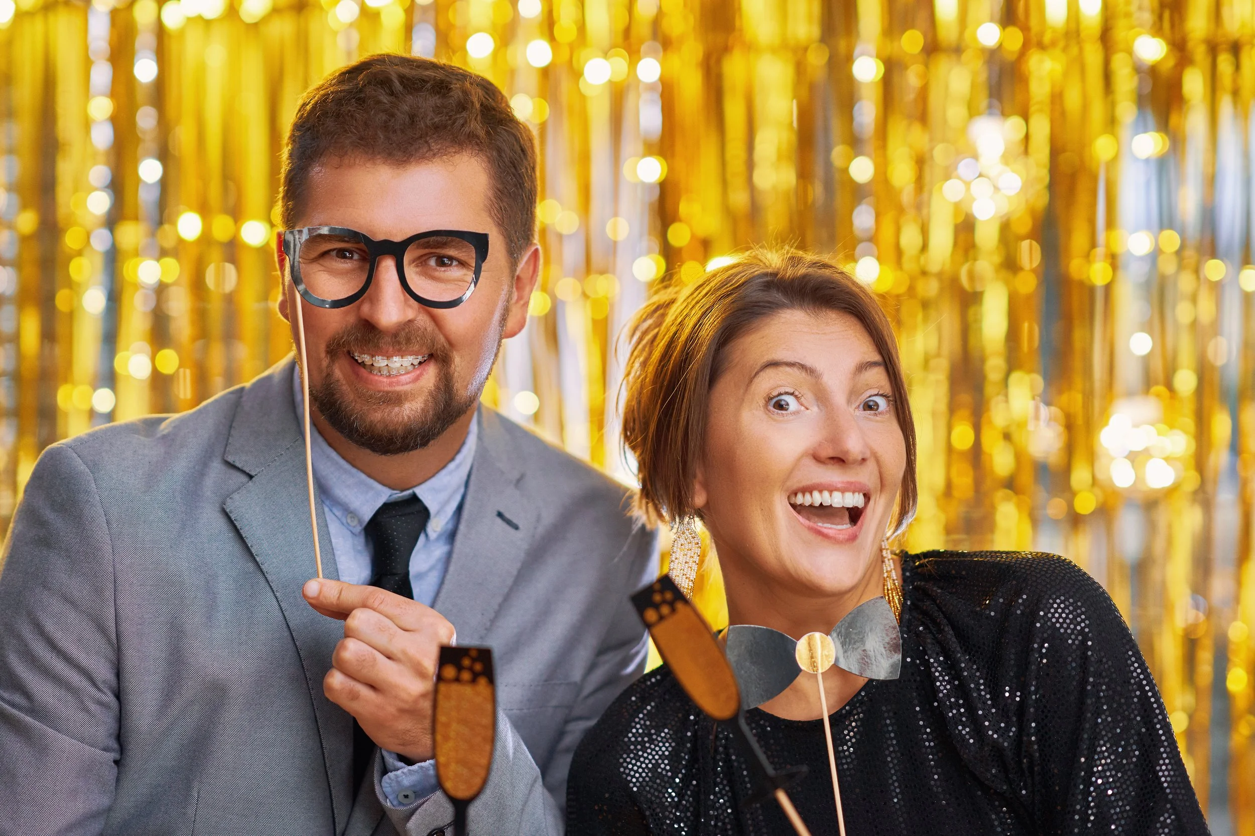 Guests engaging with a professional photo booth at a designed event experience