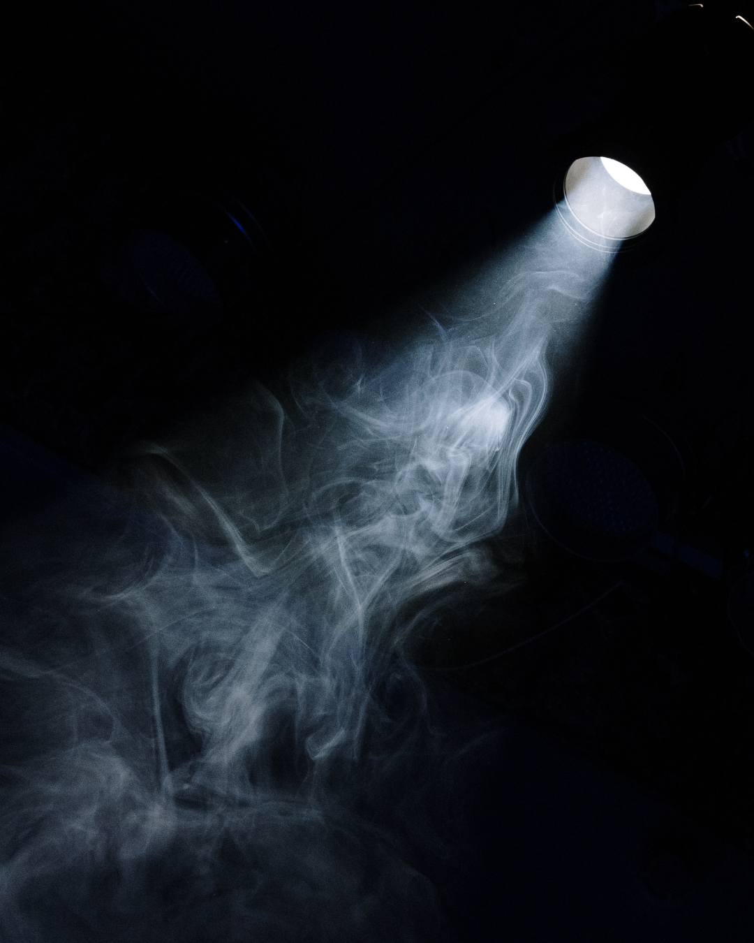 Spotlight with smoke drifting through the light