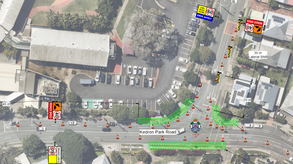 Aerial view of a roadwork site on Kedron Park Road, showing traffic cones, warning signs, and green shaded zones for construction. Nearby parking lot and residential houses visible.