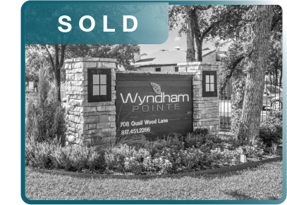 SOLD sign for Wyndham Pointe at 708 Osual Wood Lane with contact number 817-451-2266, in front of a stone entrance with trees and bushes.