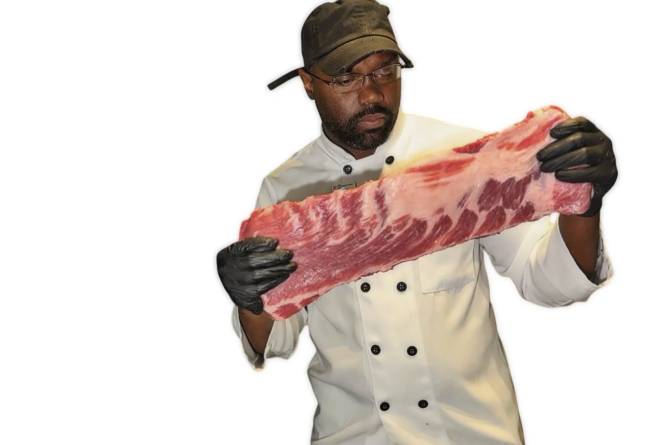 Melvin Da Chef, Dallas-based food reviewer and culinary content creator holding premium cuts of meat