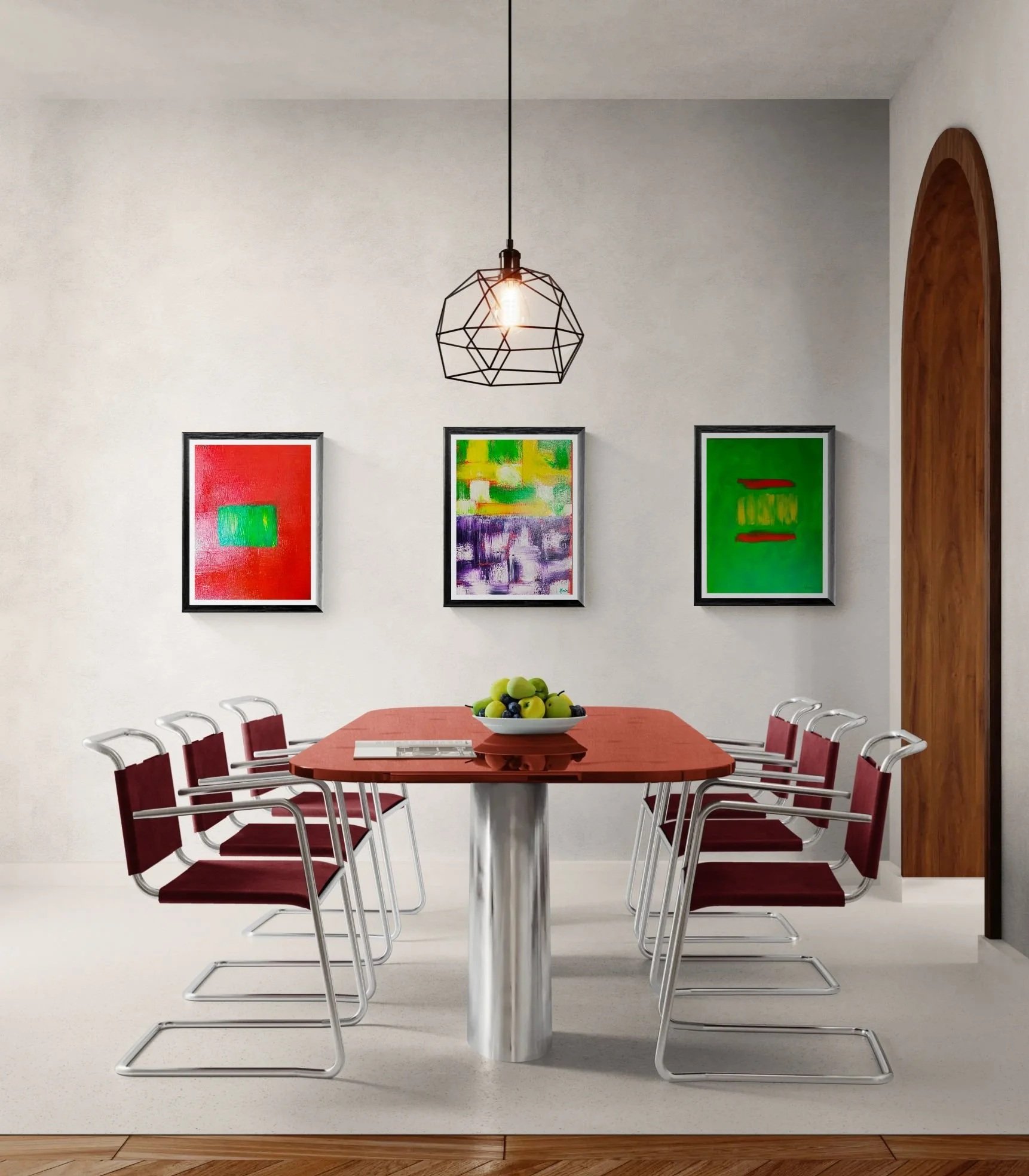 A modern dining room with a rectangular wooden table, red chairs, abstract art on the walls, a pendant light fixture, and a bowl of green apples.