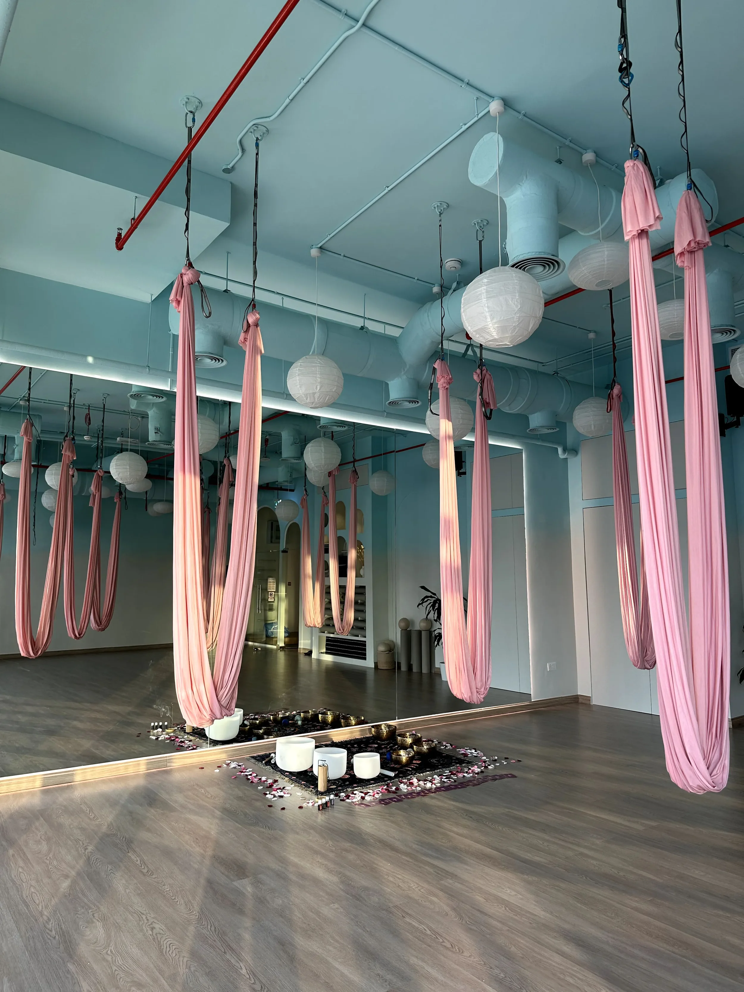 Hammock sound healing session setup with suspended hammocks and Tibetan singing bowls prepared for trauma-informed deep relaxation and nervous system regulation in Dubai.