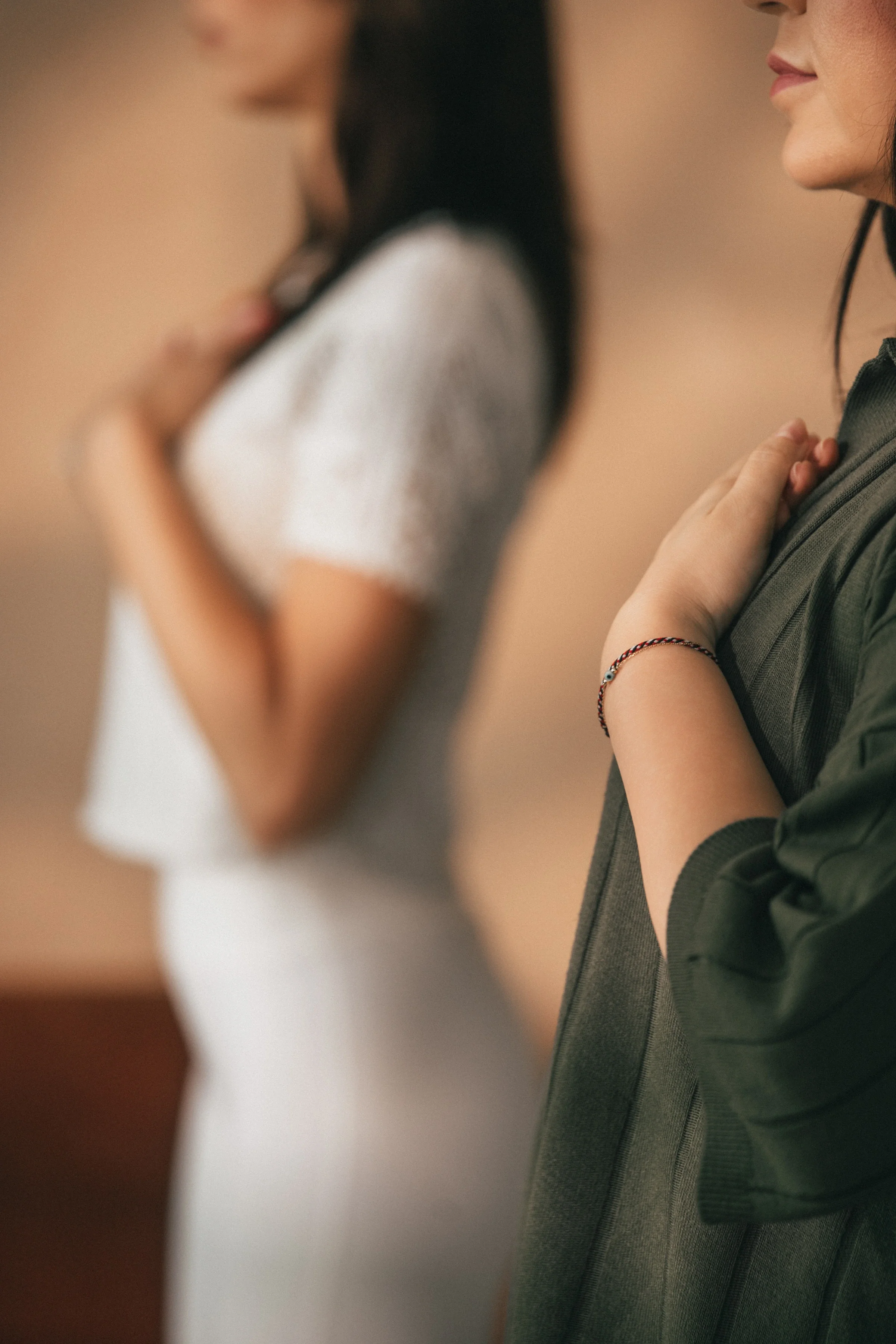 Vanessa Hartmann standing with a client practicing grounding breathwork with hands on chest to support nervous system regulation during a somatic breathwork session in Dubai.