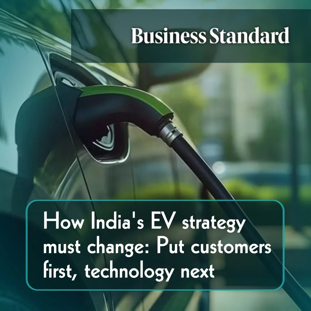 Electric vehicle charging plug connected to a car at a charging station.