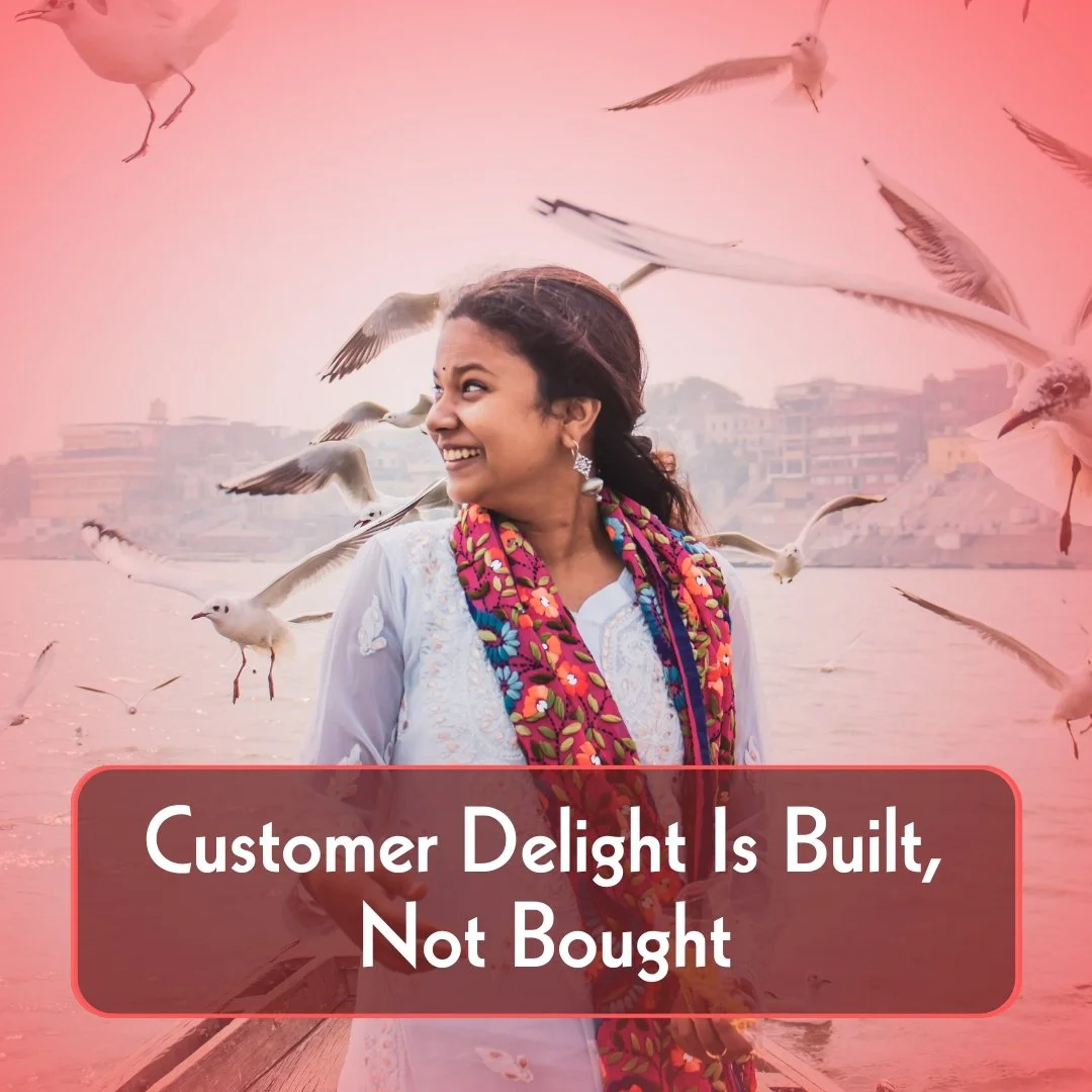 Image link to a thought leader article titled 'Customer Delight Is Built, Not Bought'. A happy woman customer is depicted in an urban setting.