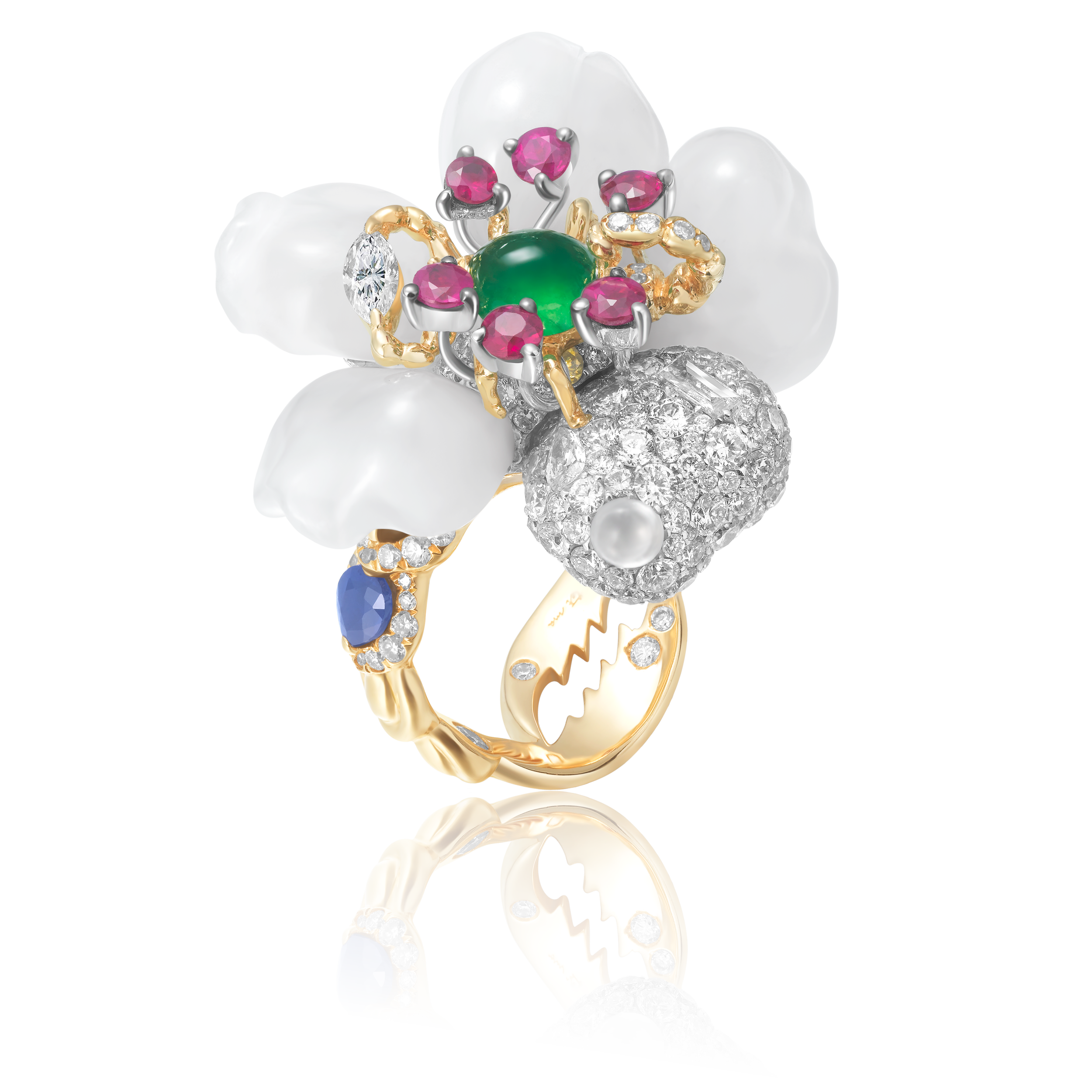 An 18k gold ring, set with a white magnolia flower carved from Hetian jade, a diamond-encrusted scorpion, a green gemstone, pink rubies, a sapphire, as well as small diamonds and pearls, all shimmering against a gleaming surface.