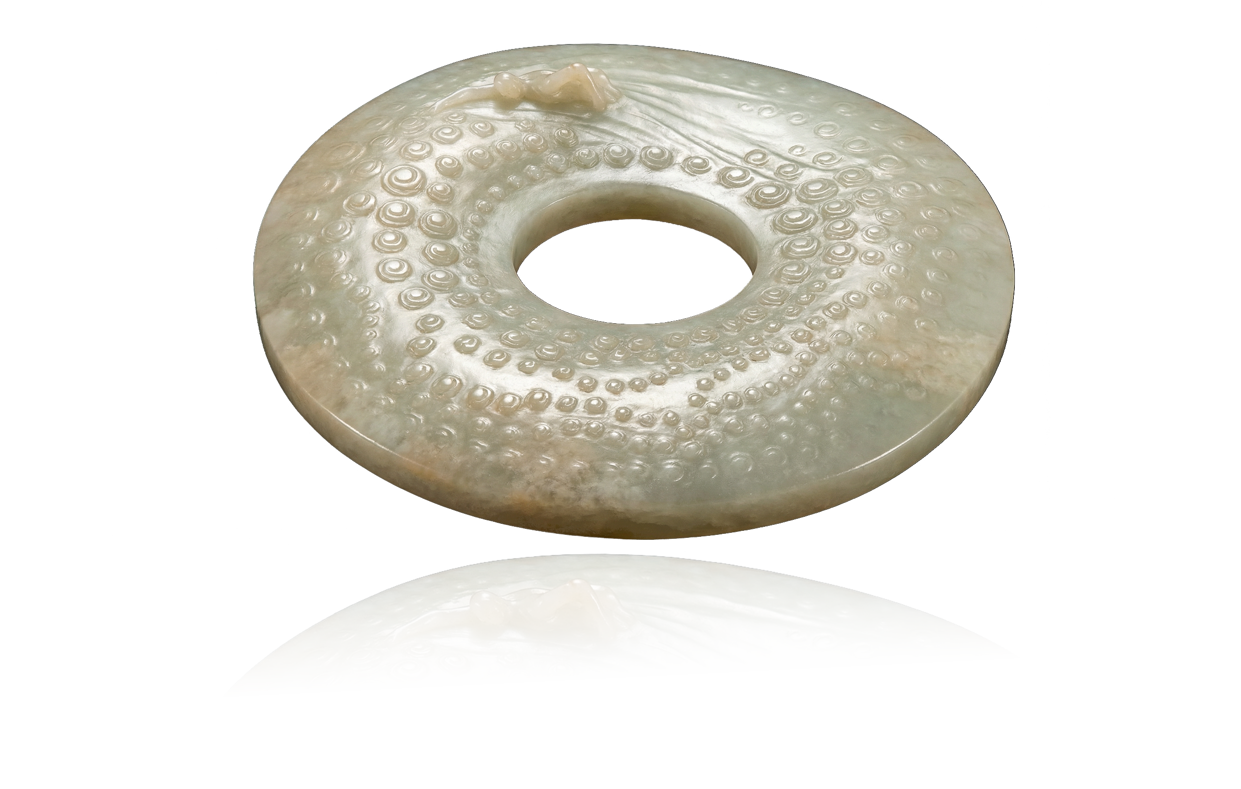 A disc of Hetian white jade, carved to depict a man swimming in a pool, its surface adorned with a nipple pattern for decoration.