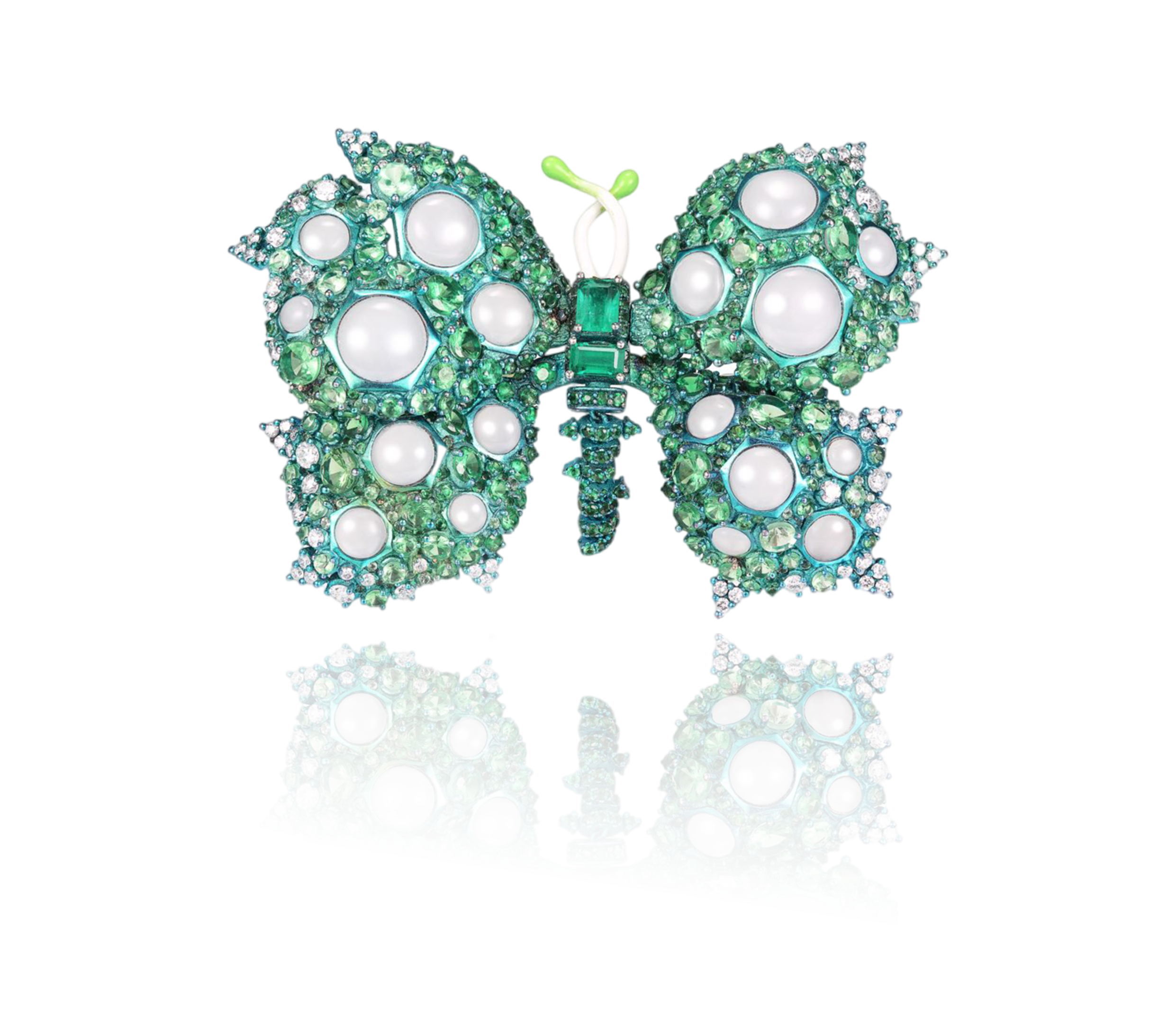 Decorative butterfly-shaped brooch with green and white gemstones and pearls, featuring a mirrored reflection on a black surface.