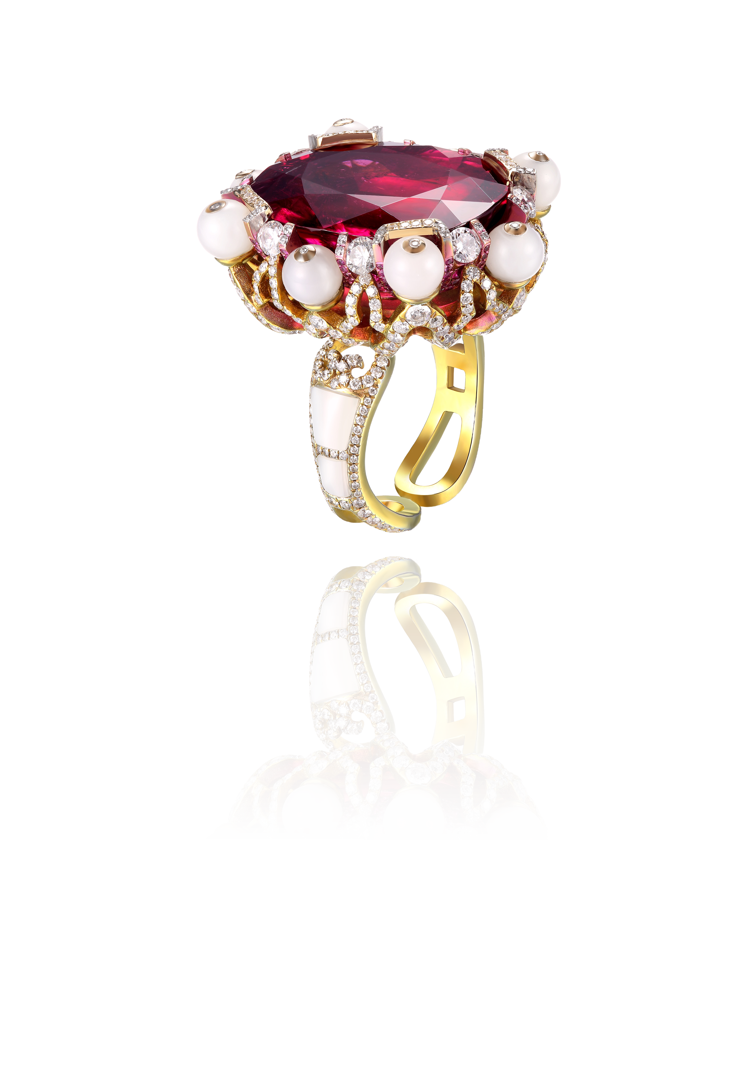 A gold ring with a large red gemstone, surrounded by pearls and small diamonds, featuring intricate gold and diamond detailing on the band.