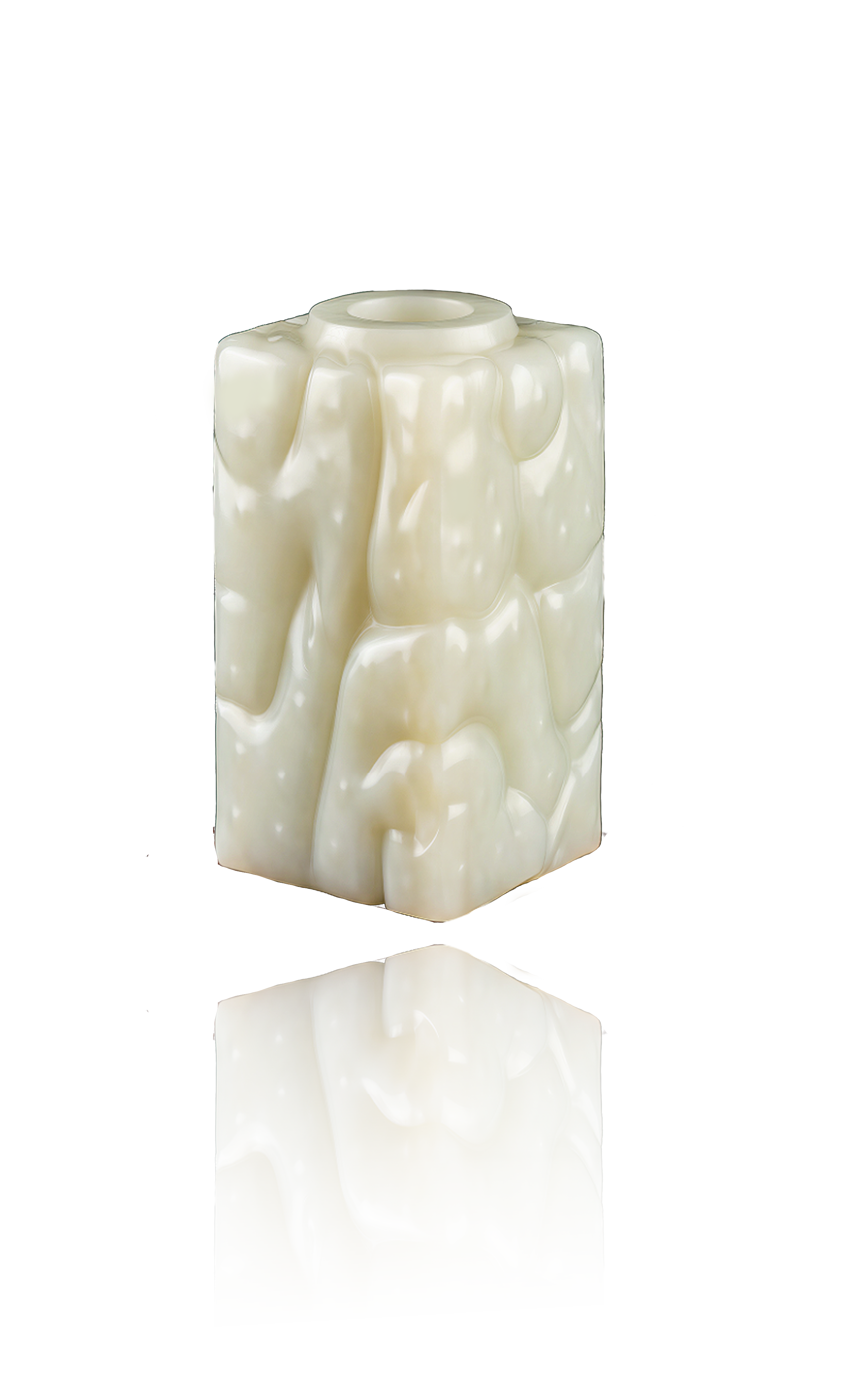 A close-up shot reveals a textured cubic jade carving, its surface glowing with a warm jade luster.