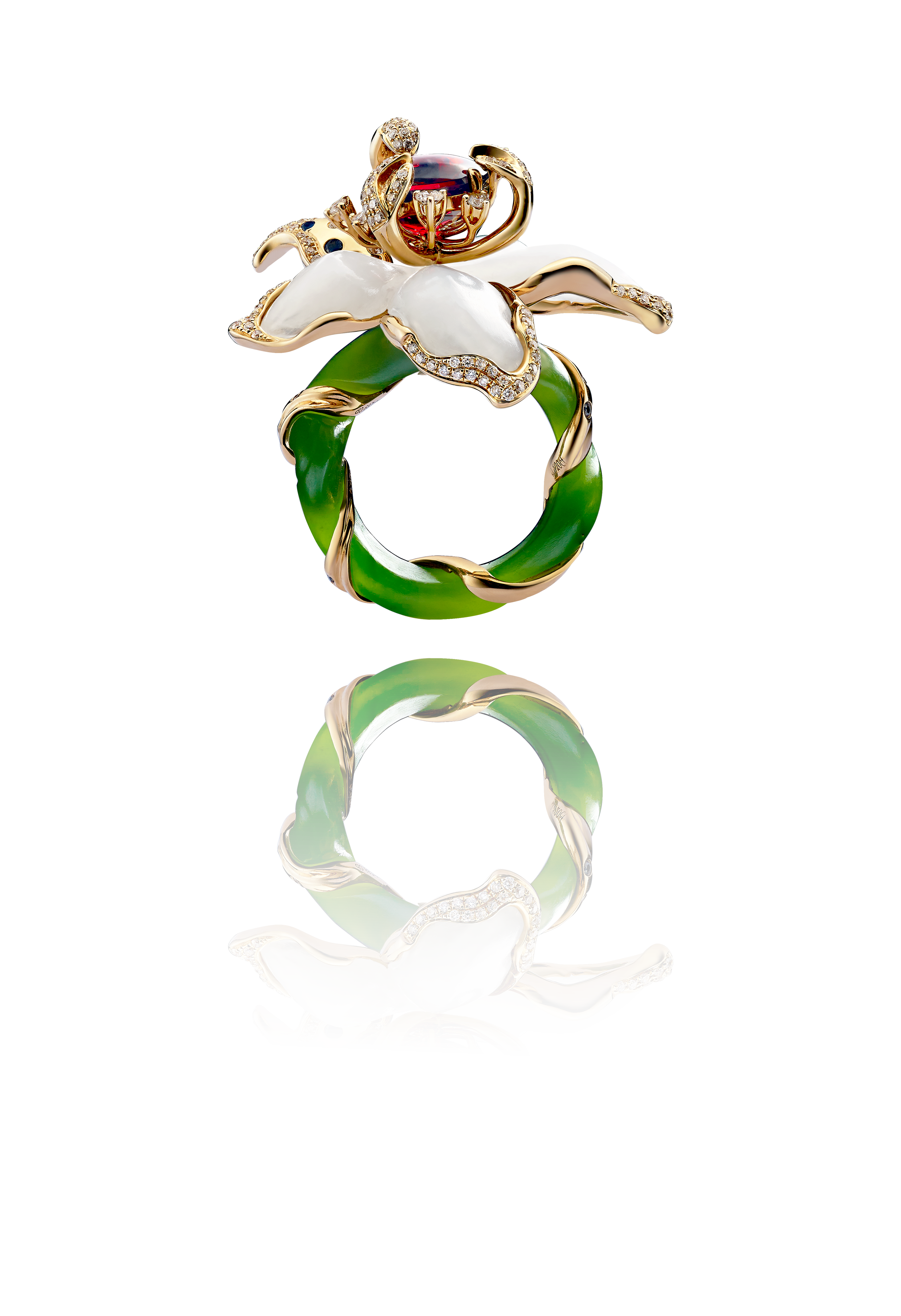 Elegant ring with white floral design, green and gold twisted band, and a red gemstone at the top.