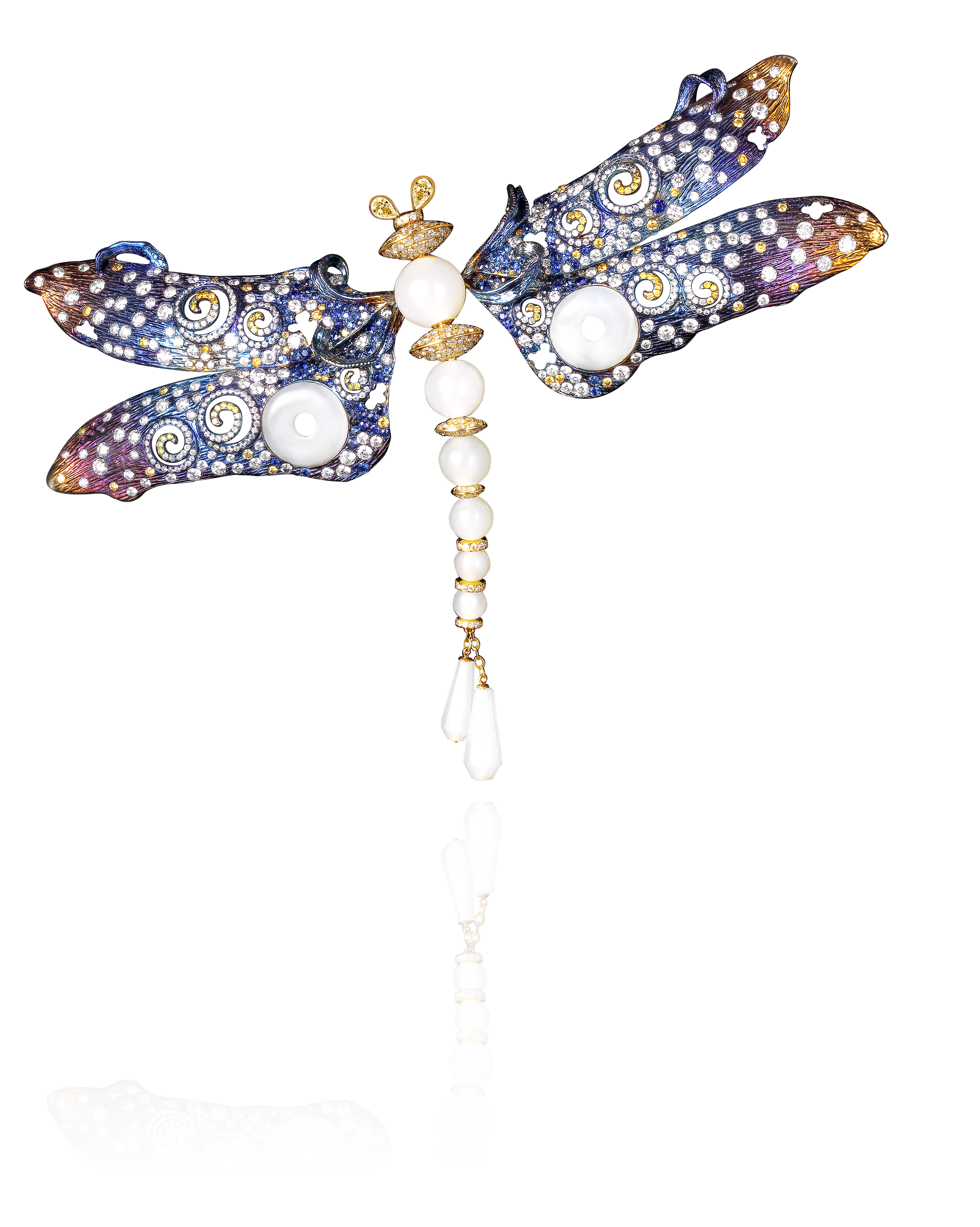A jewelry brooch in the shape of a dragonfly with wings decorated with blue, white, and clear stones, and a body composed of white pearls and gold accents.