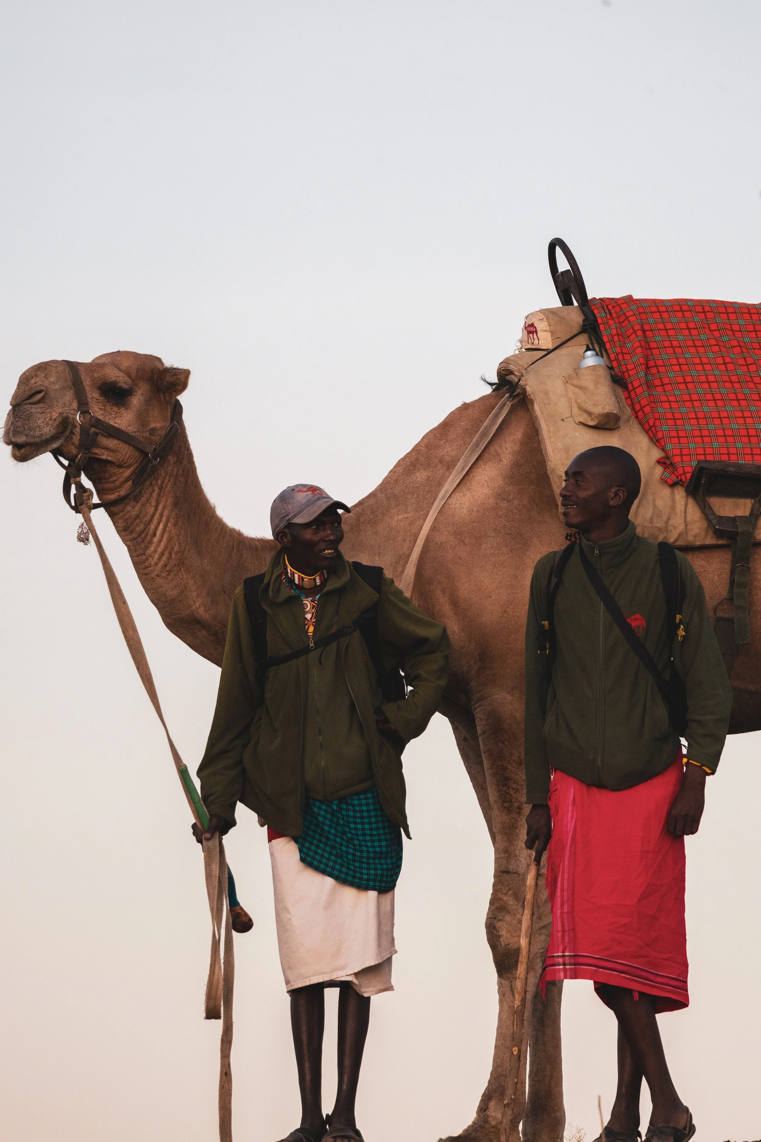 Two local guides and their camel at Tumaren Camp in Laikipia, Kenya