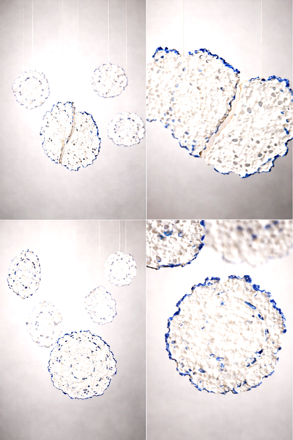 Décorations suspendues en forme de cercles blancs avec un contour bleu, disposées en plusieurs groupes.
