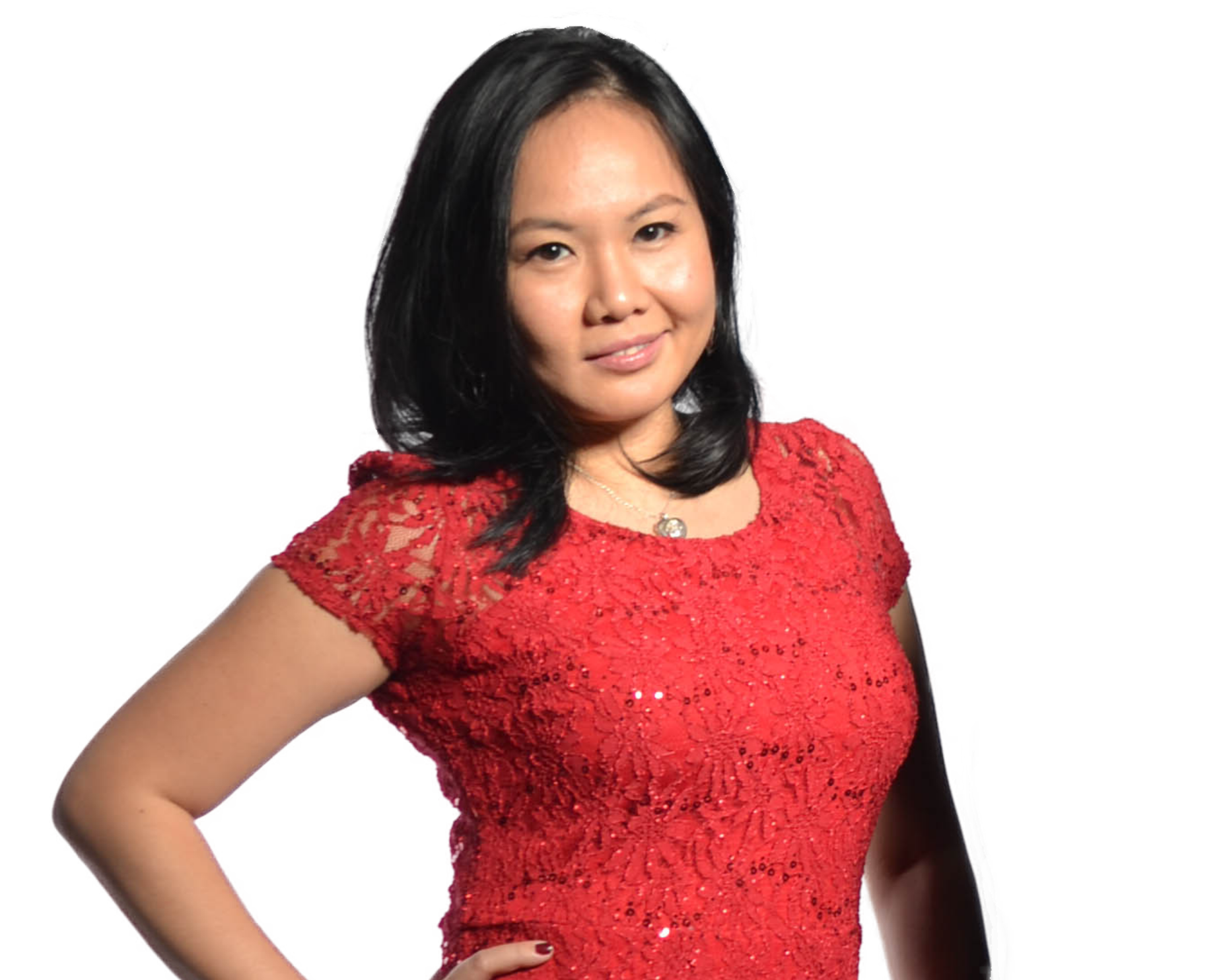 A woman wearing a red lace dress with sequins, posing with one hand on her hip and smiling slightly..Rowena J Augustine