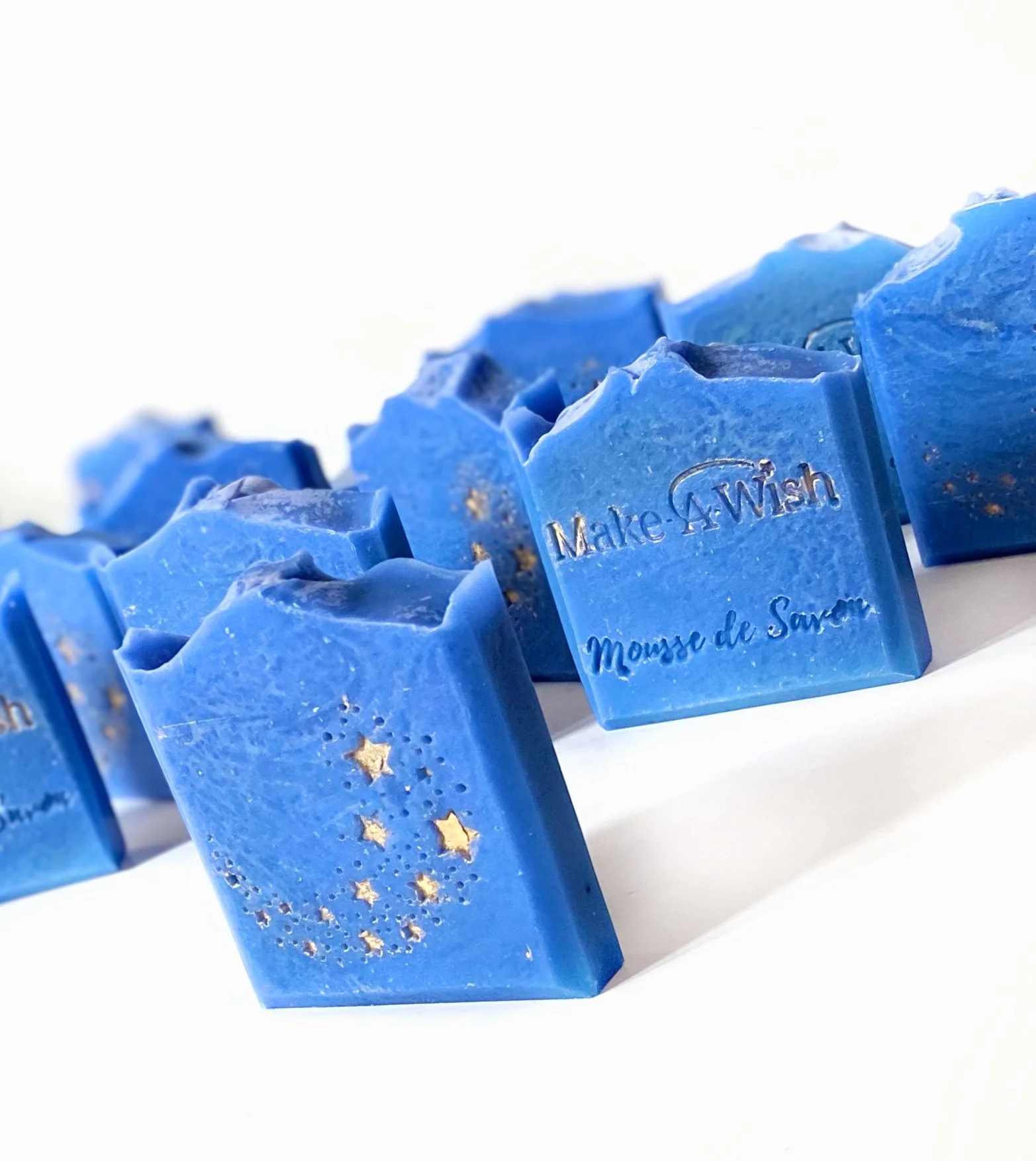 Blue soap bars with gold stars and moon cutouts, inscribed with 'Make A Wish' and 'Mouse de Sève'.