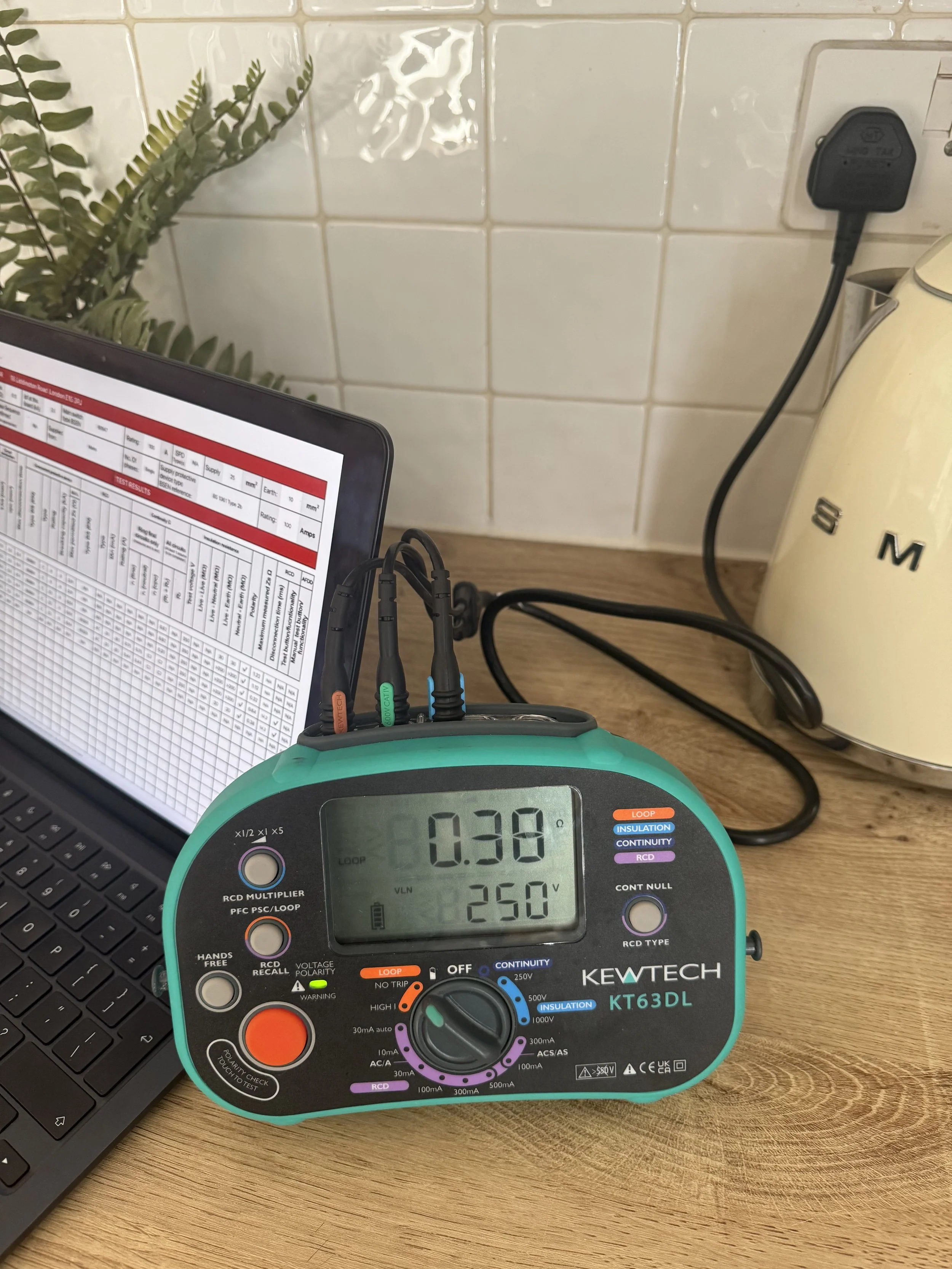 Electrical Multifunctional tester, with smug kettle and Eicr in the back ground