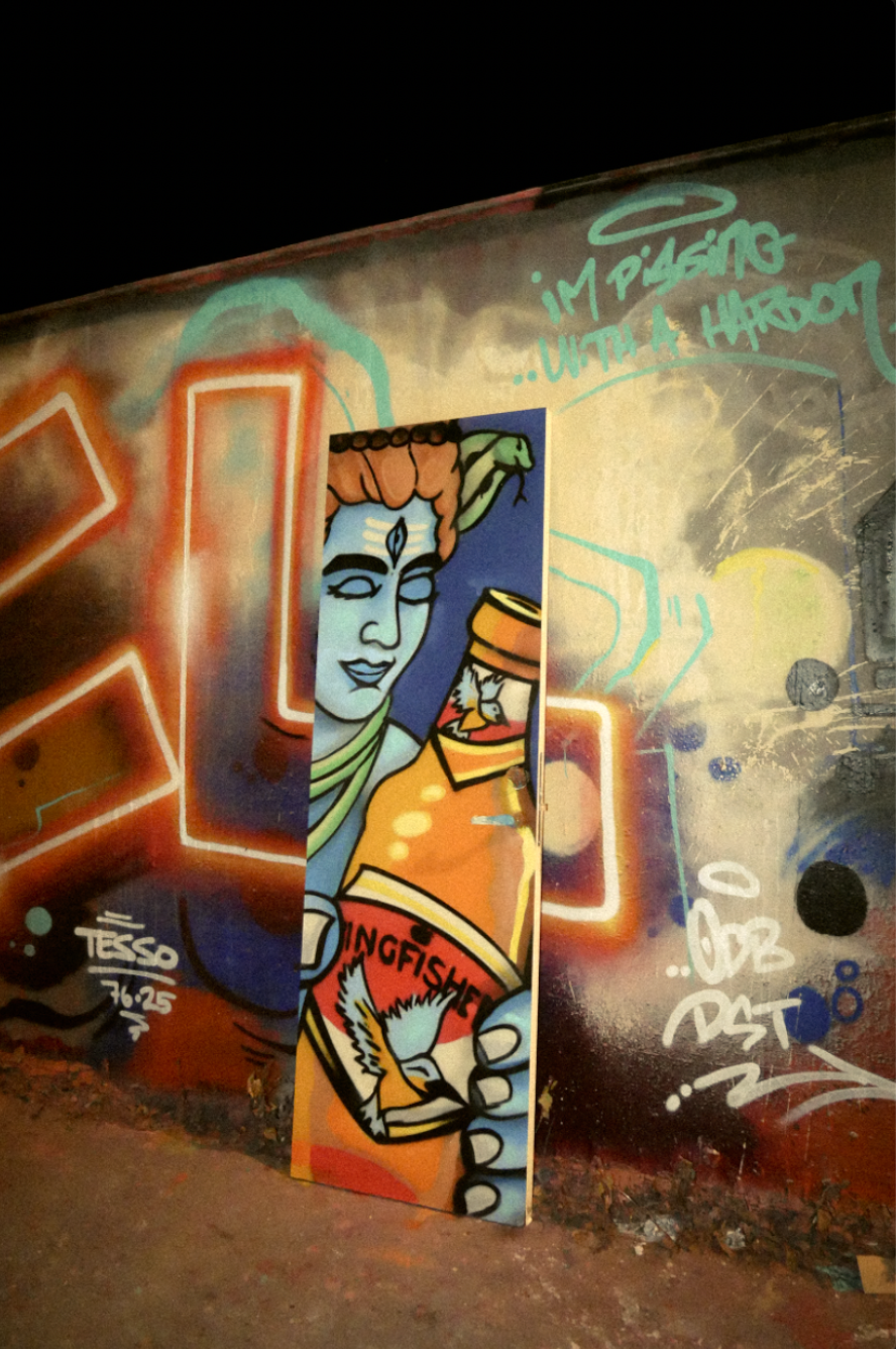 A graffiti painted door by Graffiter to Spice graden in Stockholm. Colorful graffiti mural featuring a woman with a third eye holding a can of Longfisher beer, with various graffiti tags and phrases around.
