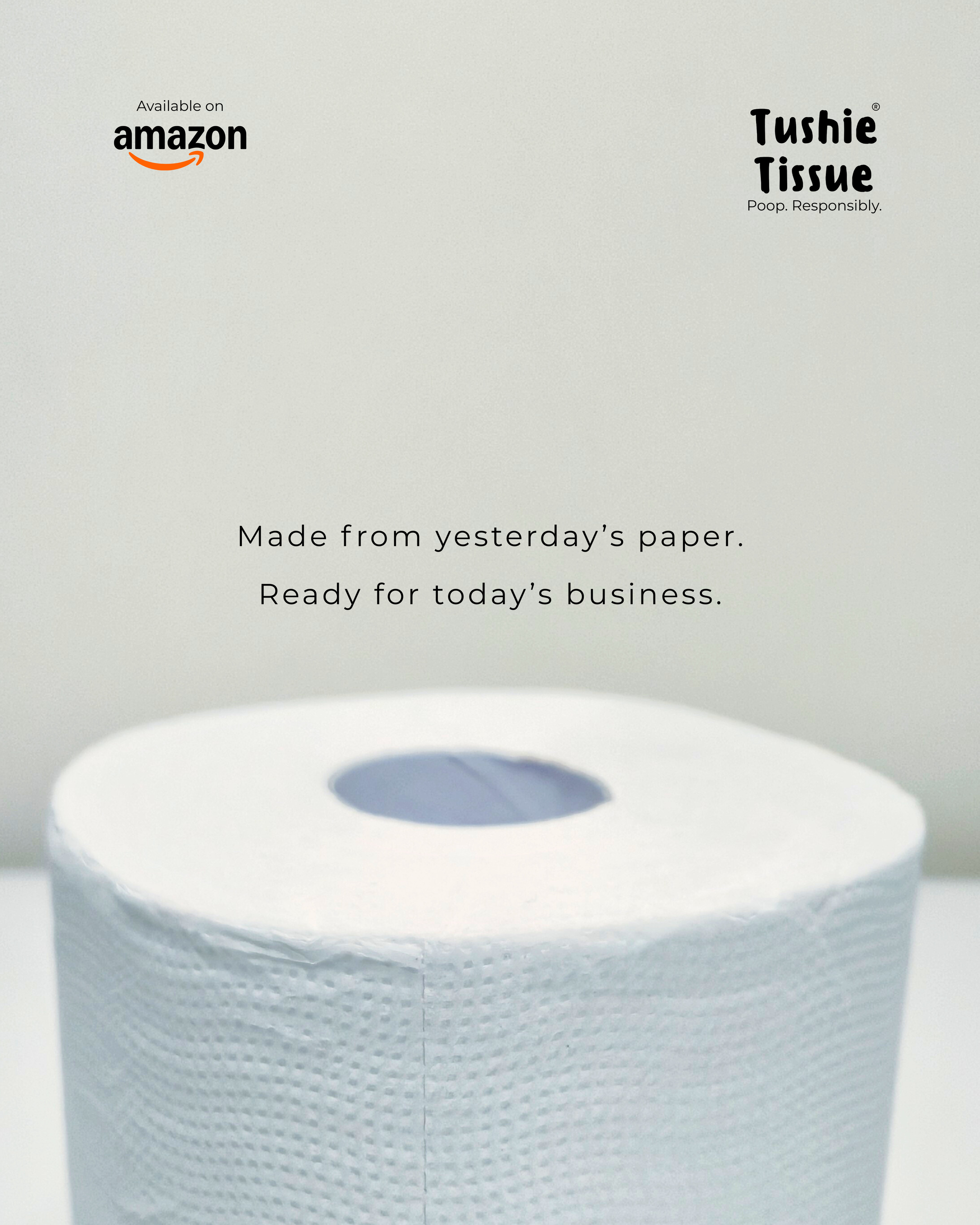 A roll of toilet paper with a plain white background, featuring text about Tushie Tissue paper and Amazon, stating 'Made from yesterday's paper. Ready for today's business.'