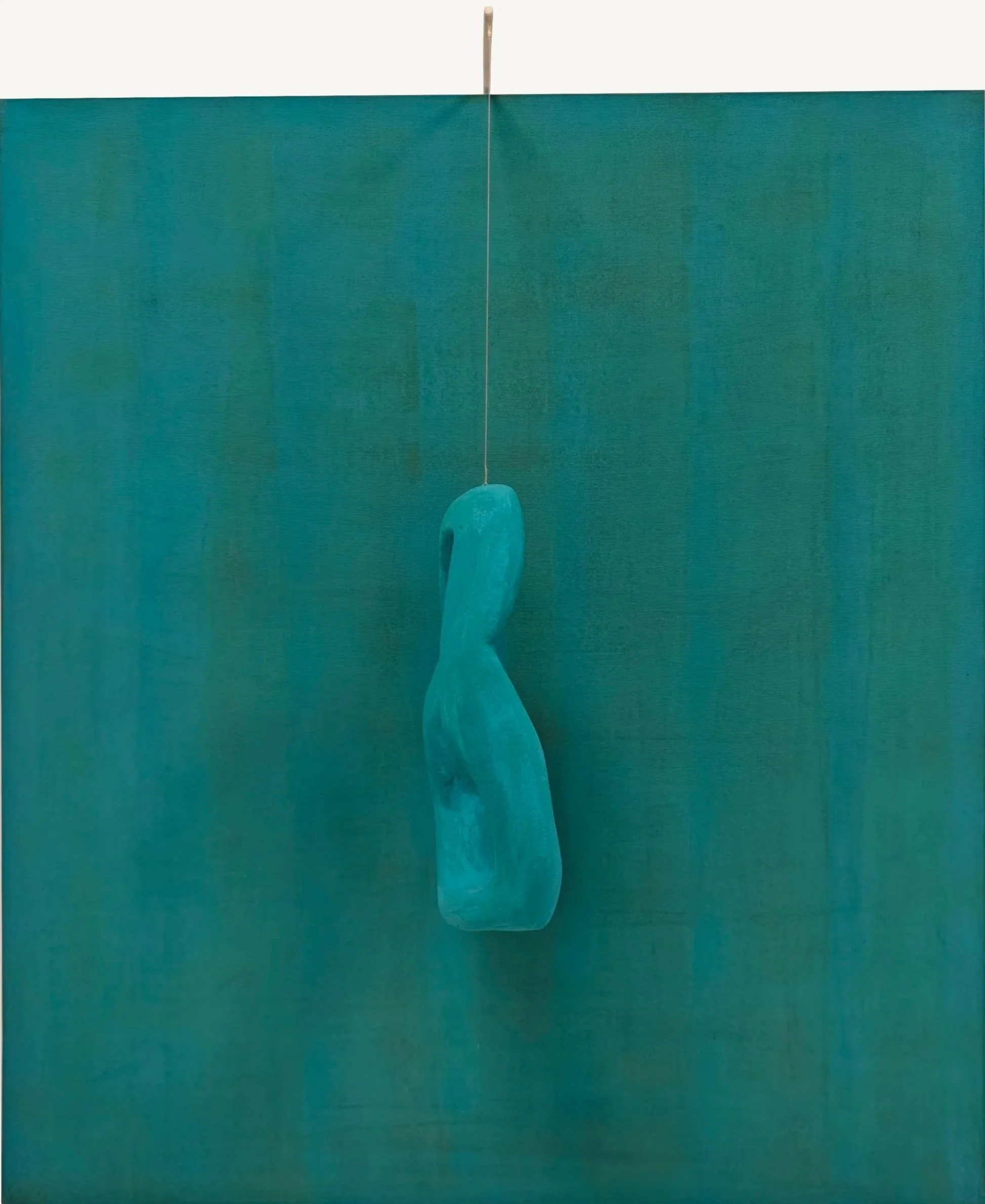 Una scultura moderna di colore blu suspended in aria, con sfondo verde