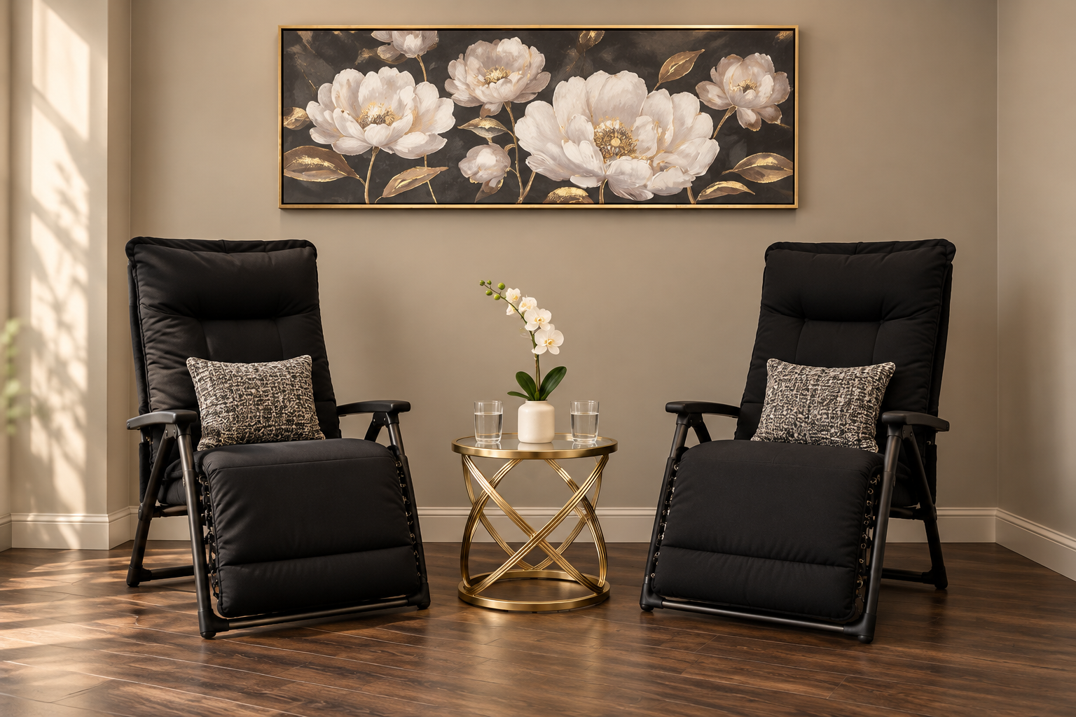 Two black armchairs facing each other beside a gold and glass side table with a white orchid in a calm treatment room