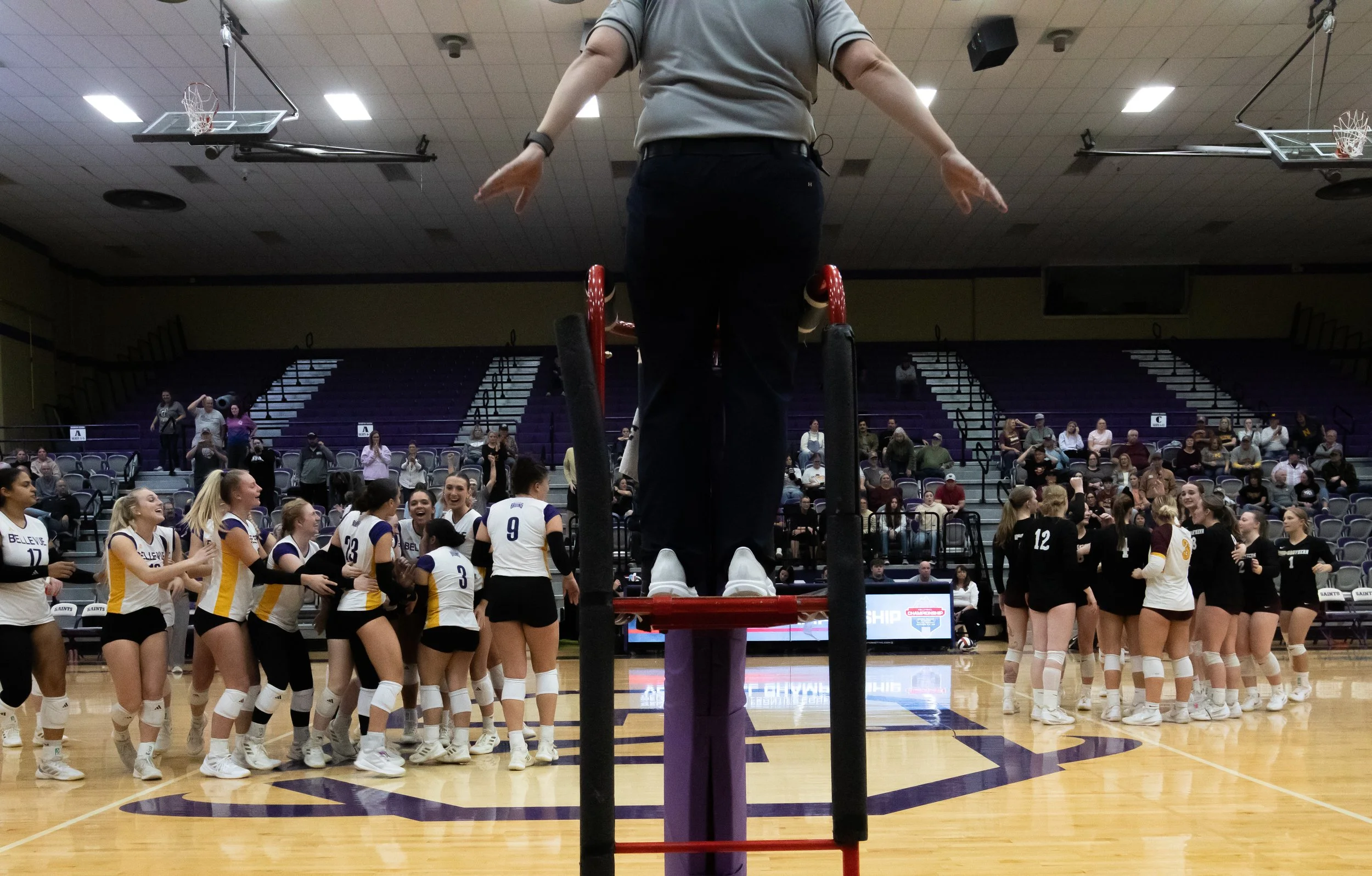The Bellevue Bruins, left, cheer after they defeat the MSU-Northern Skylights November 14, 2025, during the semifinal round of the Frontier Conference Volleyball Championship.