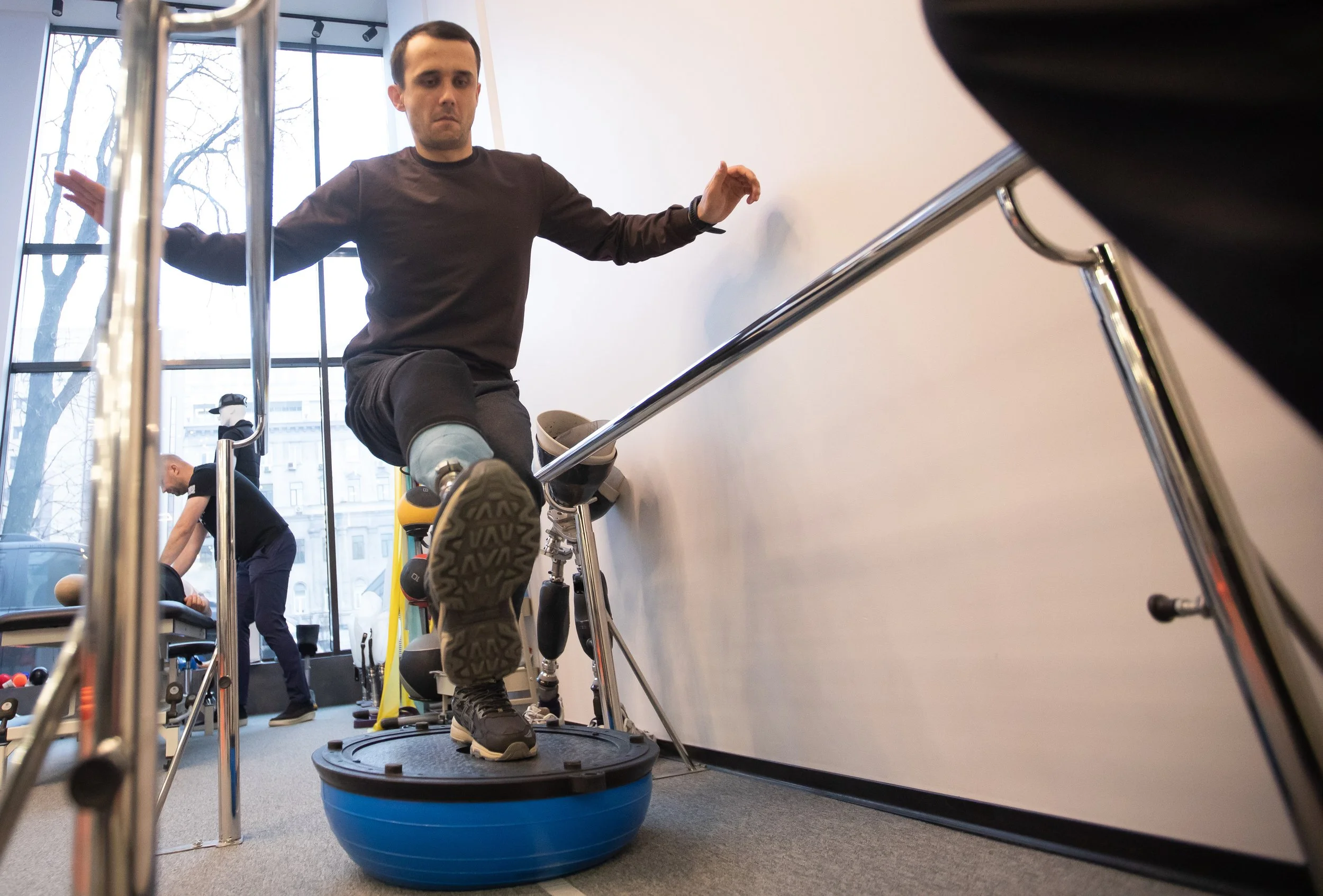 Mykhailo Marochkanych balances himself during a physical therapy session at the Protez Foundation in Kyiv, Ukraine Dec. 1, 2025.