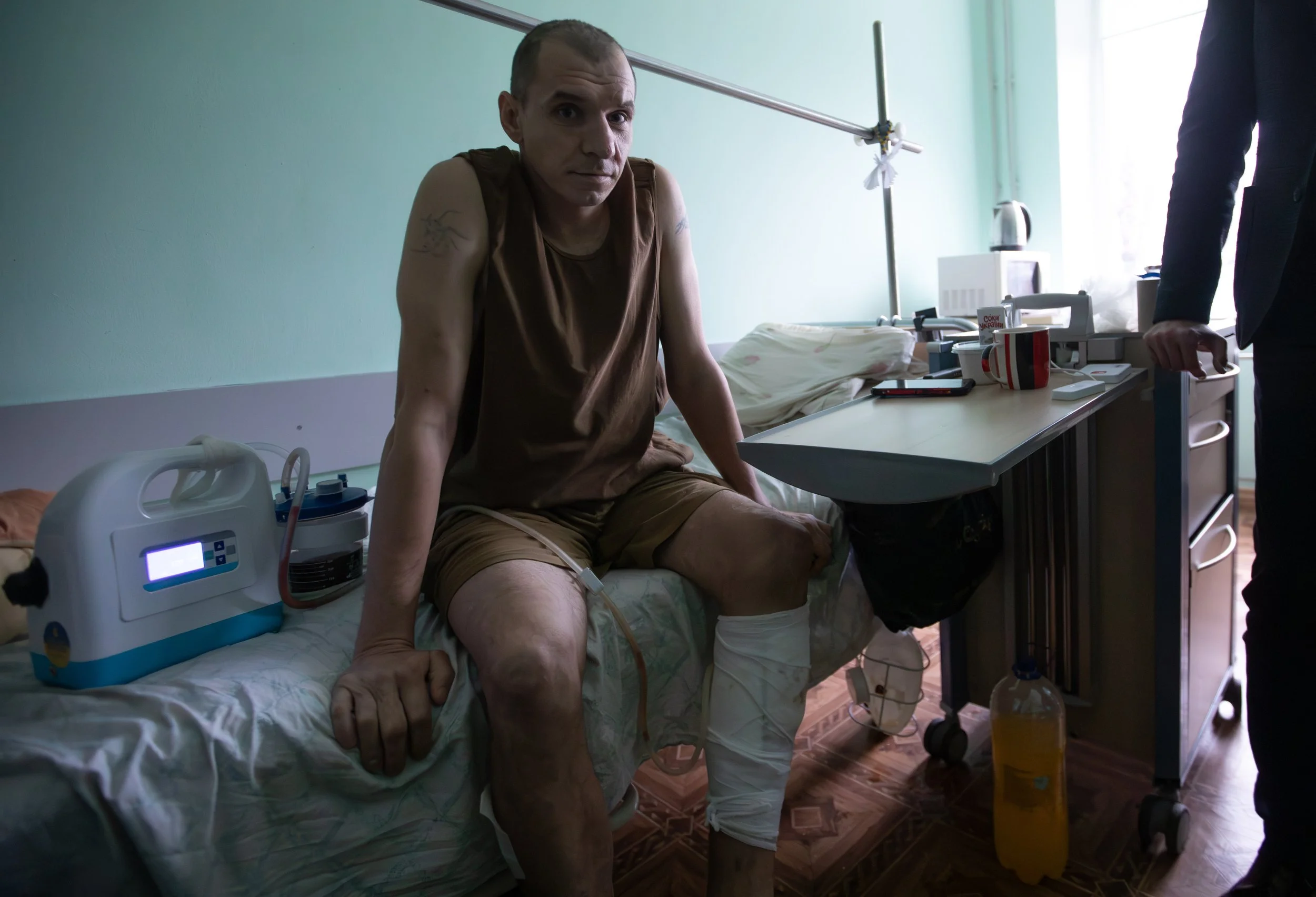 Volodymyr, injured on the front lines by a drone strike, sits on his hospital bed at the Zhytomyr Regional Clinical Hospital on Nov. 23, 2025.