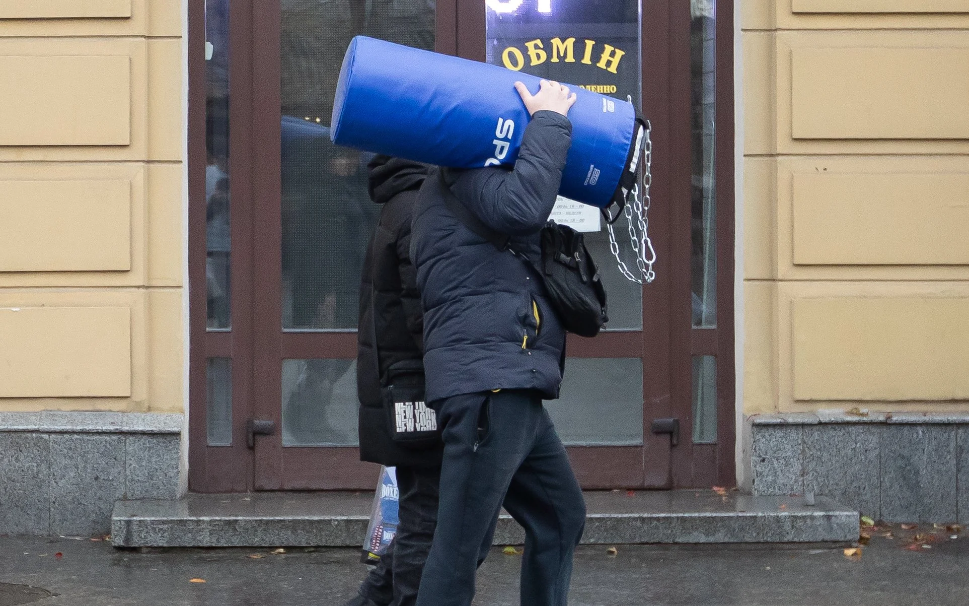A man carries a punching bag through the streets of Zhytomyr, Ukraine Nov. 22, 2025.