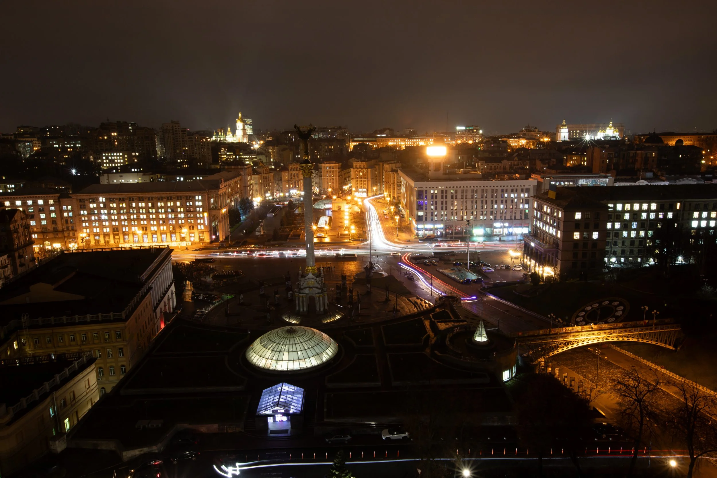 Kyiv, Ukraine’s city center glows Nov. 26, 2025 from street lights and cars driving on the road.