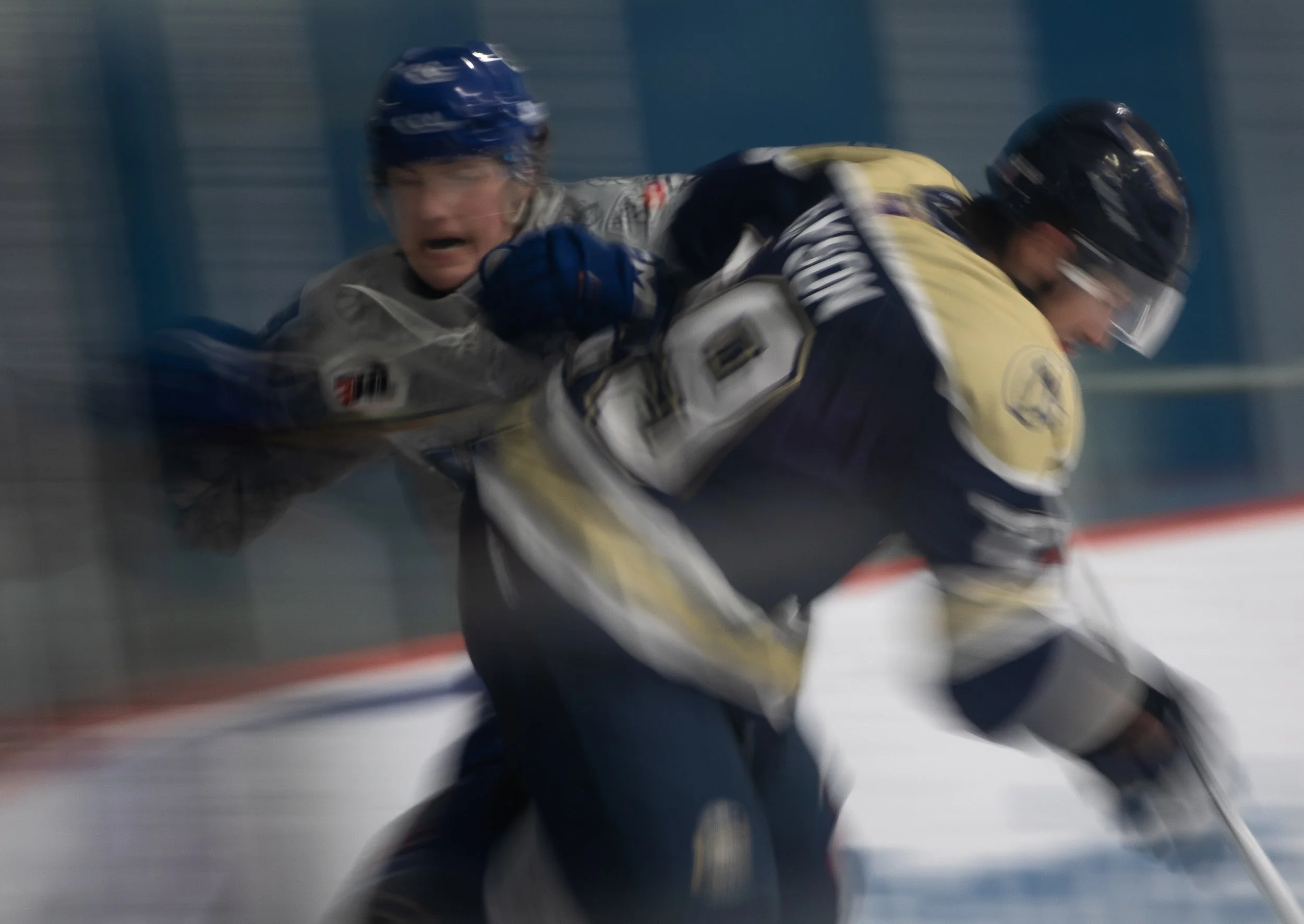 A Helena Bighorns player is smashed against the glass by a Yellowstone Quake player Jan. 3, 2026 at Steed Arena.