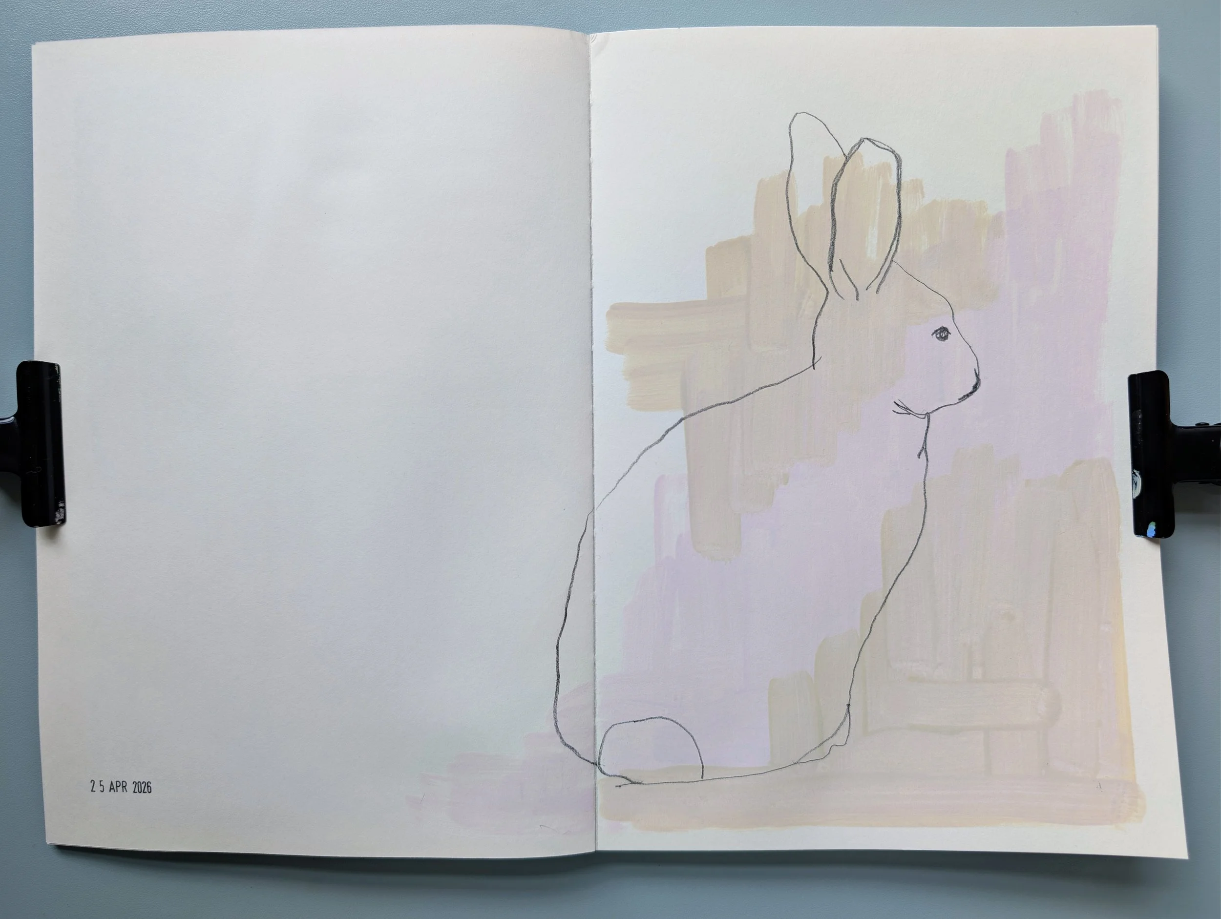 Open sketchbook with a simple line drawing of a rabbit's profile on the right page, with abstract pastel-colored background; blank left page, date '25 APR 2026' at bottom left.