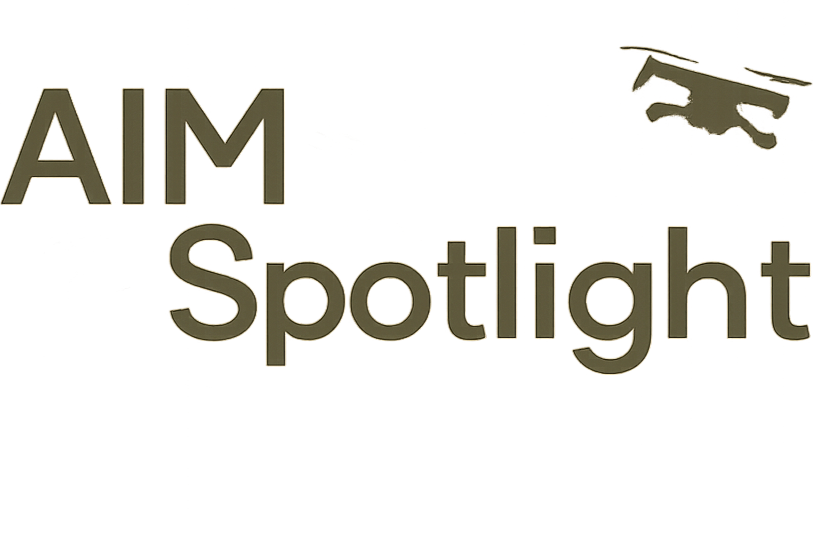 Text on a background with a partially visible spotlight shining on the words "AIM Spotlight"