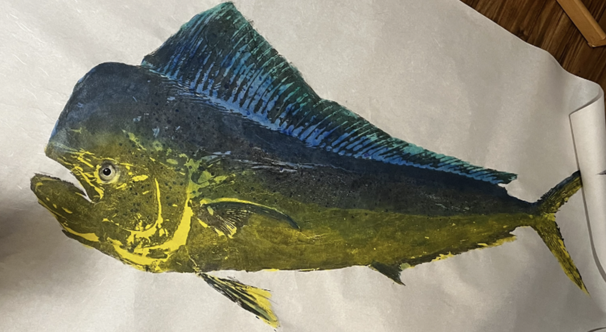 Colorful fish illustration with yellow, blue, and black markings on a white background.