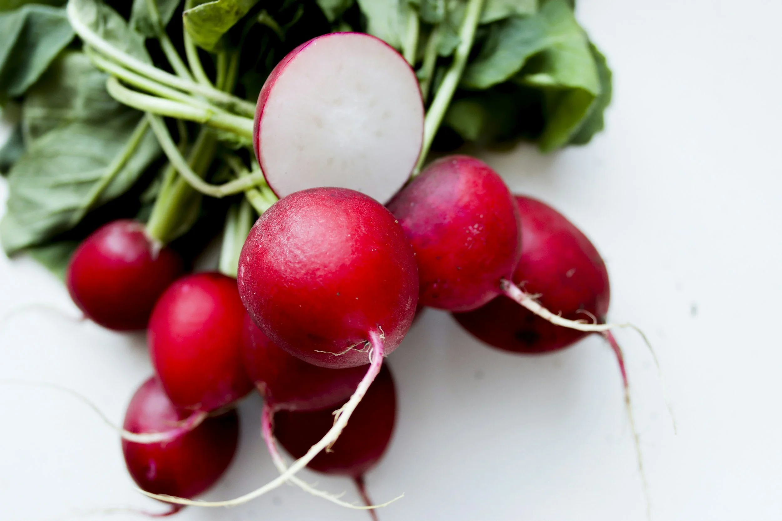 A photo of a bunch of radishes in front of a white background