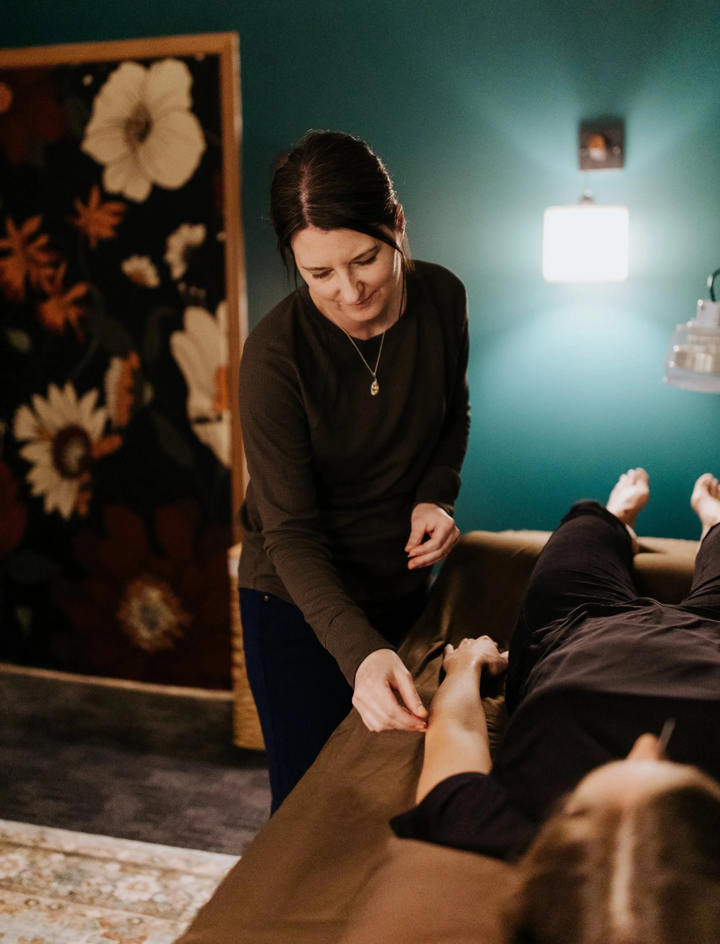 Photograph of acupuncturist Dr. Jean-Marie Cartier, inserting a needle into the arm of a female patient.