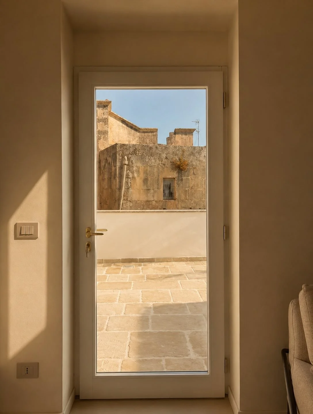 From just inside, Corigliano appears in layers &mdash; sky, stone and rooftops beyond the terrace. Views like this are a reminder that Palazzo A Mauro has always existed in close conversation with the town around it. Step outside and you&rsquo;re imm