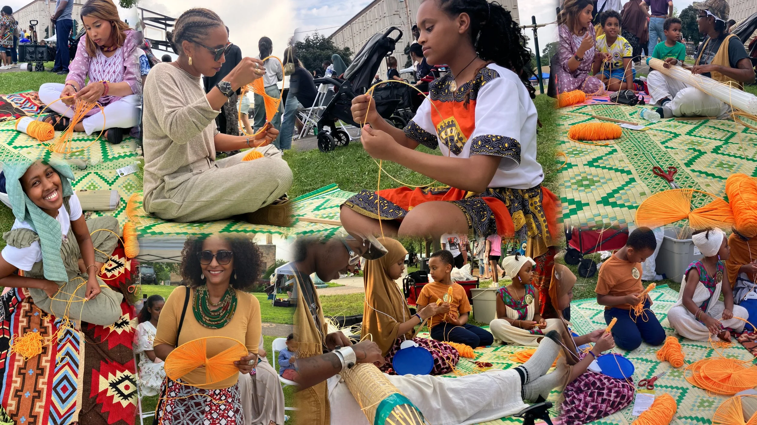 Group of people, including women and children, sitting on a grassy area at an outdoor event, weaving traditional baskets and fans with orange and yellow yarn on patterned mats. Some are smiling, others focused on craftwork, with tents, strollers, and