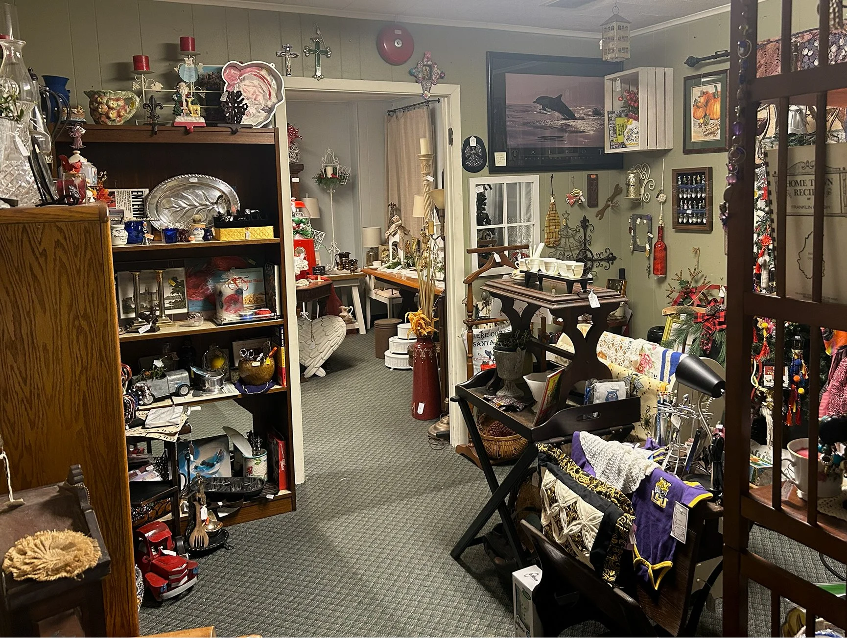Interior of a store with shelves and tables filled with various decorative items, knickknacks, and seasonal decorations.