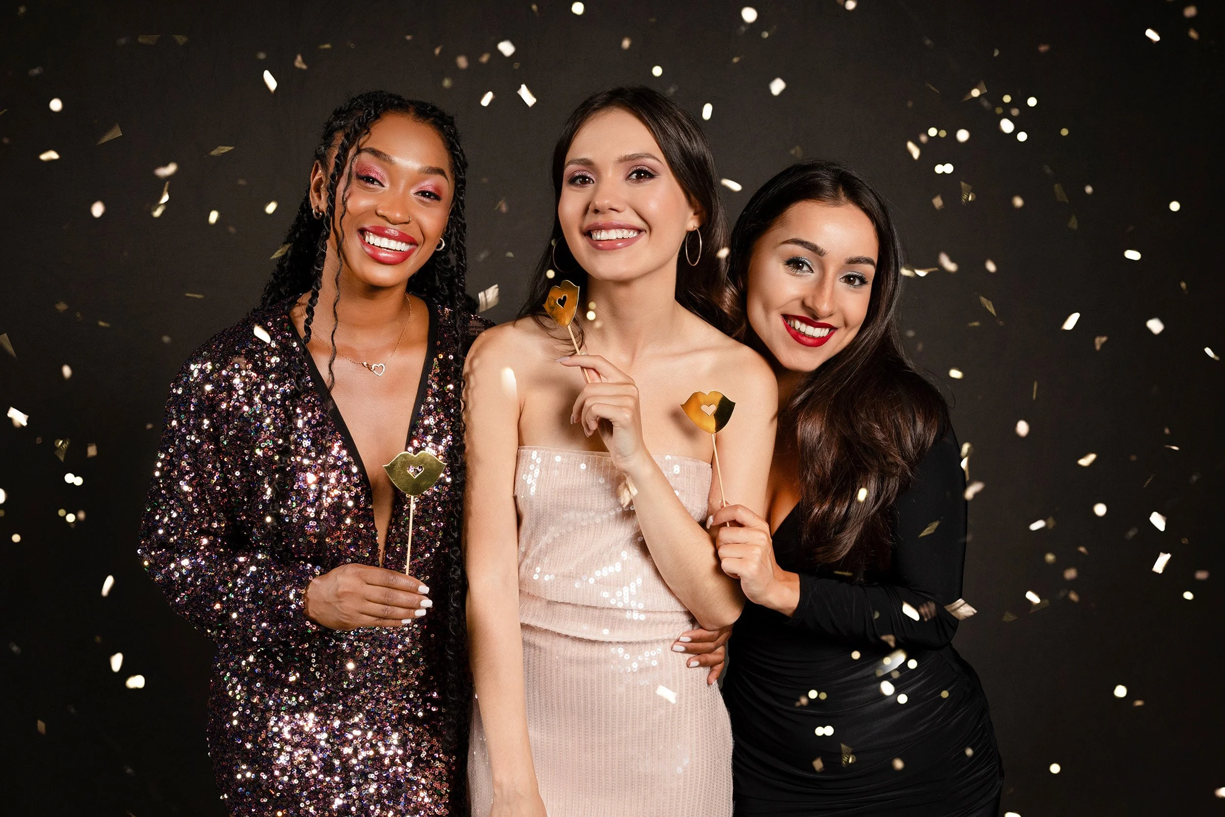 three women using Photo Booth props