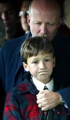 Charles and Dad as Caskets are Lowered