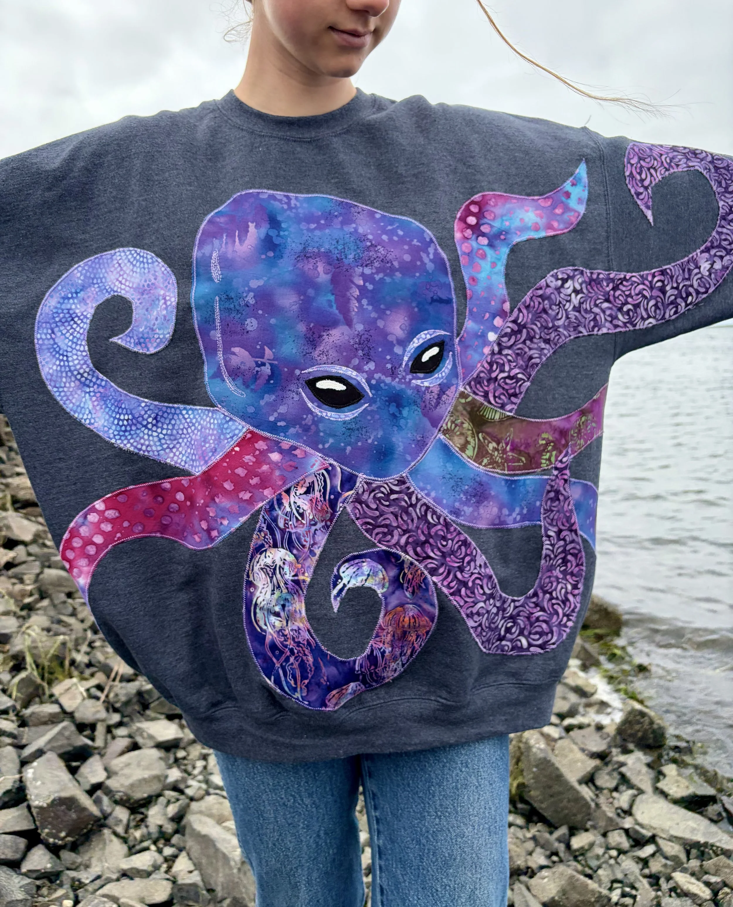 Wearable art with patchwork purple octopus.