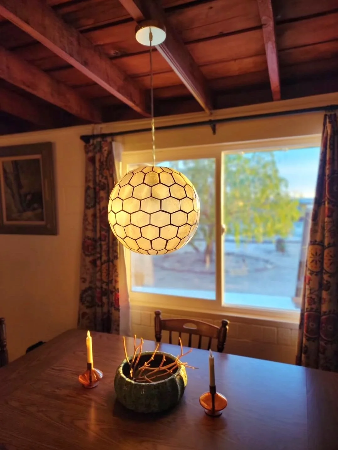 Dining area interior at Kit Fox Cabin with warm lighting and desert views in the high desert near Joshua Tree