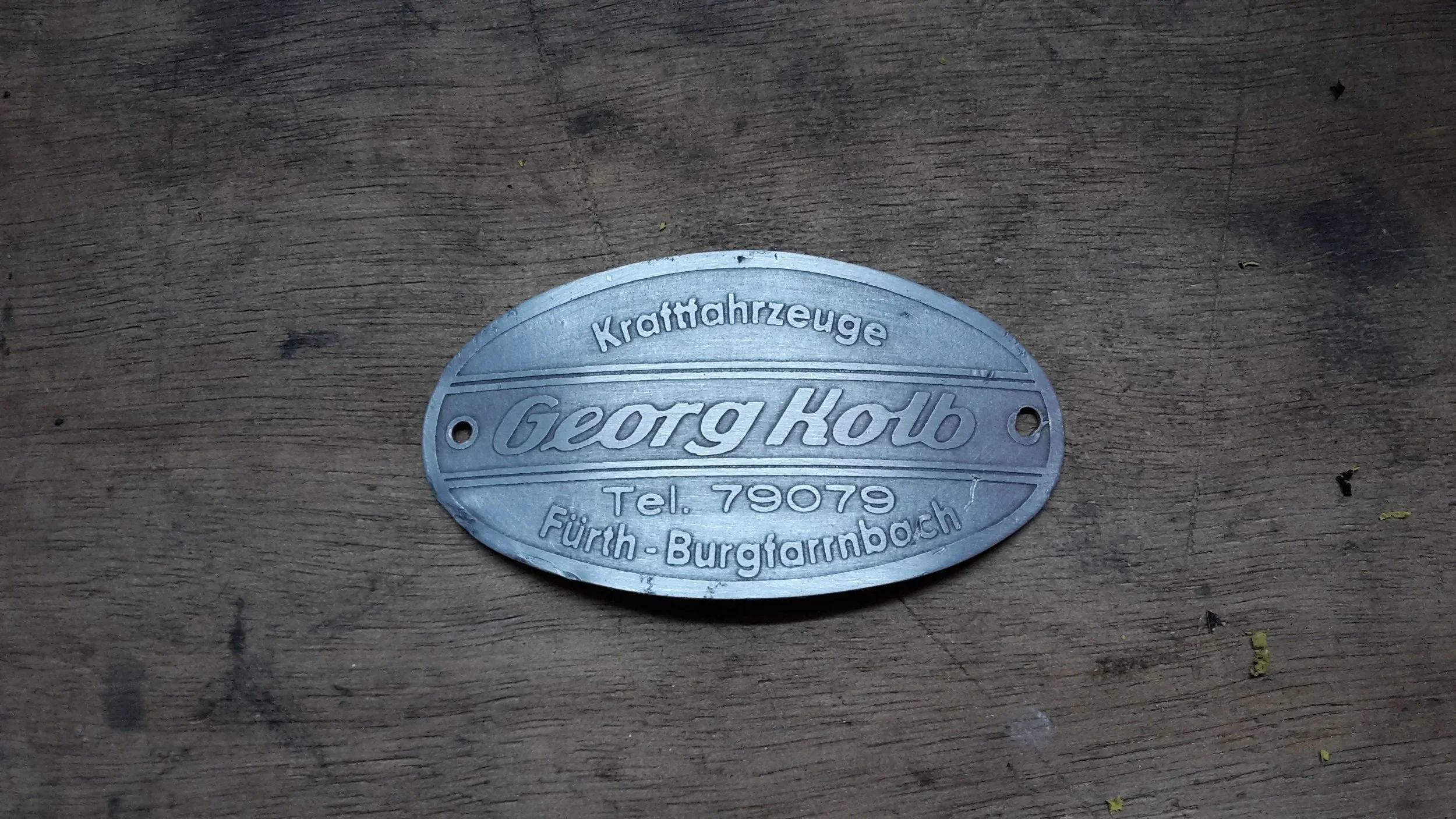 Restauration einer alten Motorrad-Plakette.