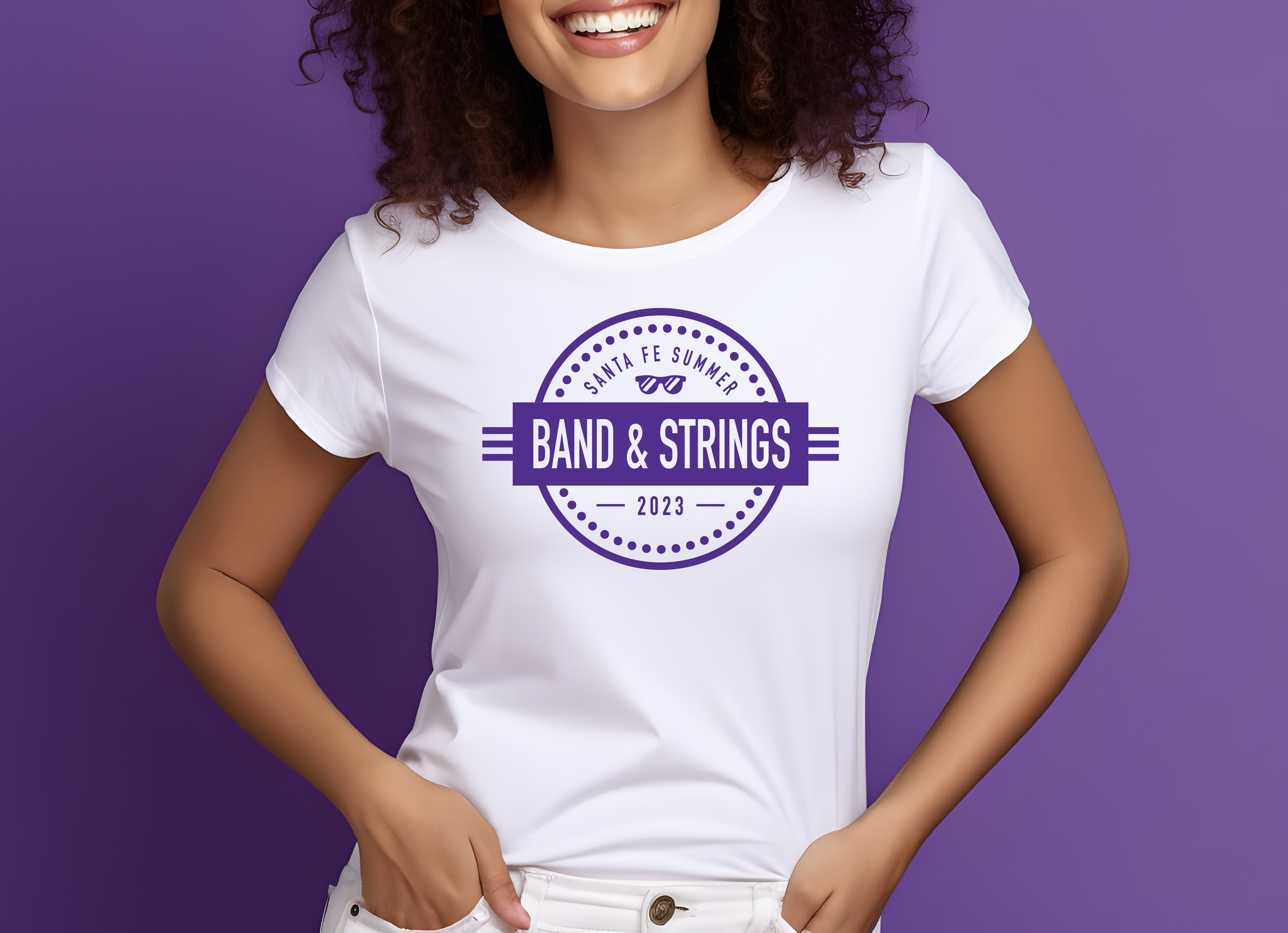 A woman wearing a white t-shirt with purple text and graphics that read 'Band & Strings 2023' and 'Santa Fe Summer,' standing against a purple background.