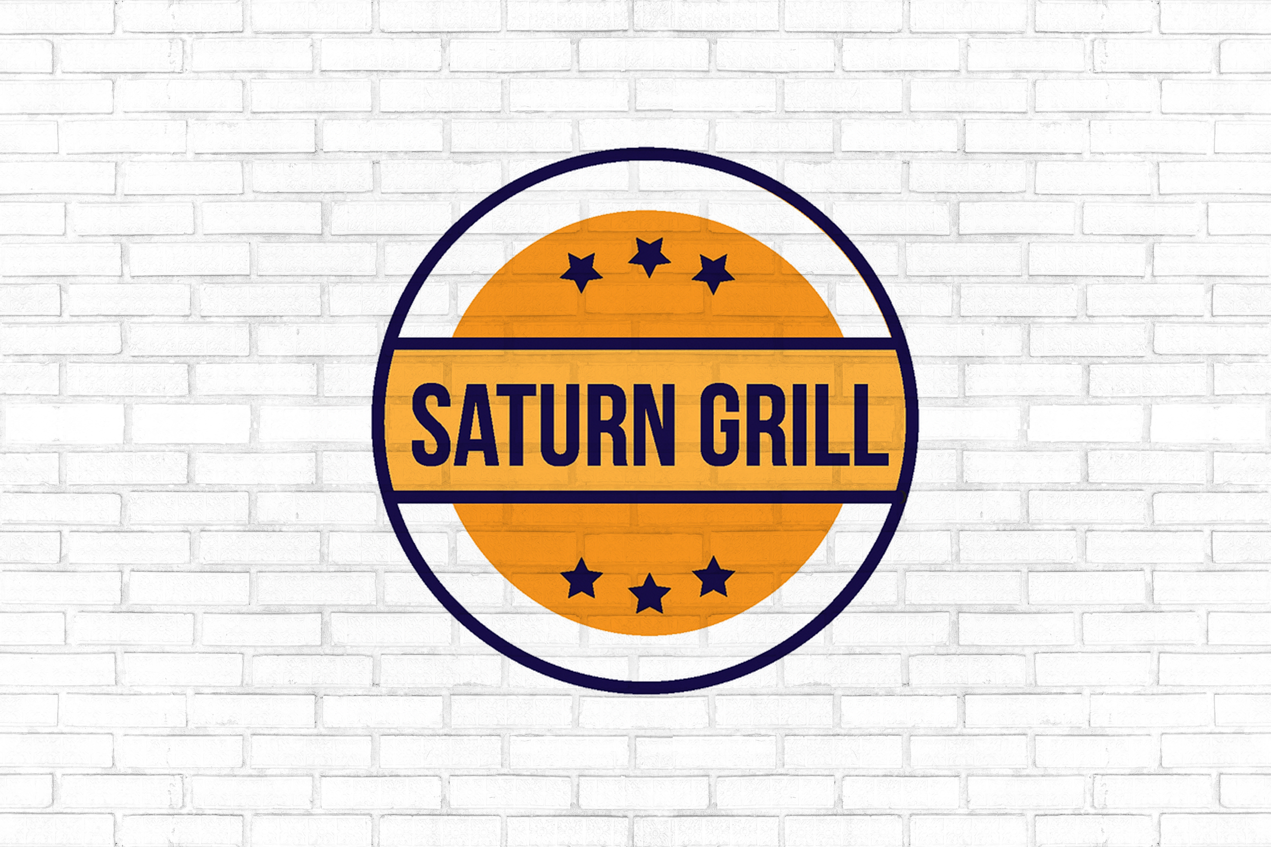 Logo of Saturn Grill featuring a circular design with a yellow-orange background, six dark blue stars, and the name 'Saturn Grill' in bold dark blue text.