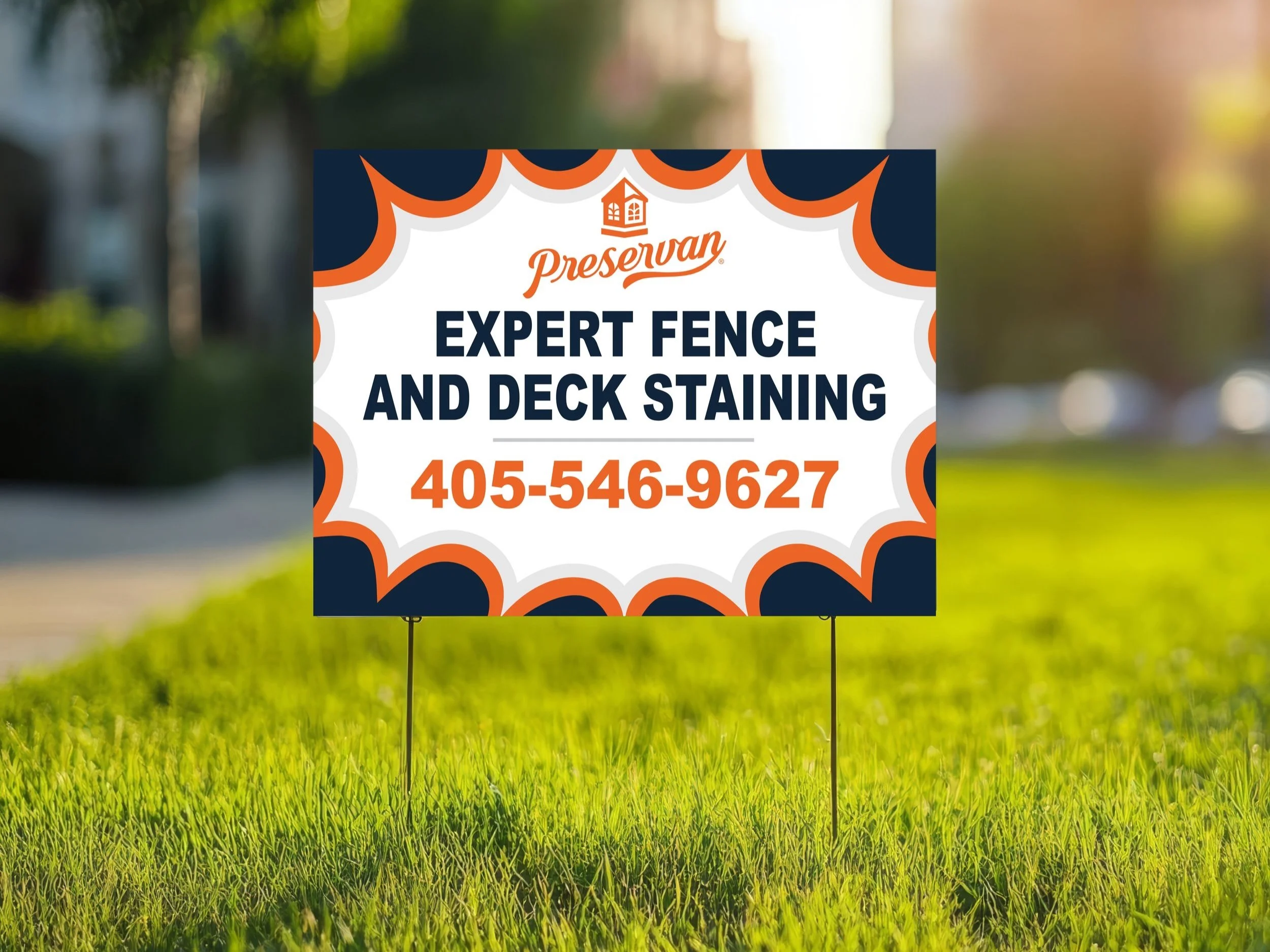 Sign advertising expert fence and deck staining services with a phone number, placed on a grassy lawn in sunlight.