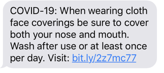 Text message about COVID-19 mask-wearing guidelines, emphasizing covering nose and mouth and washing face coverings regularly, with a link for more information.